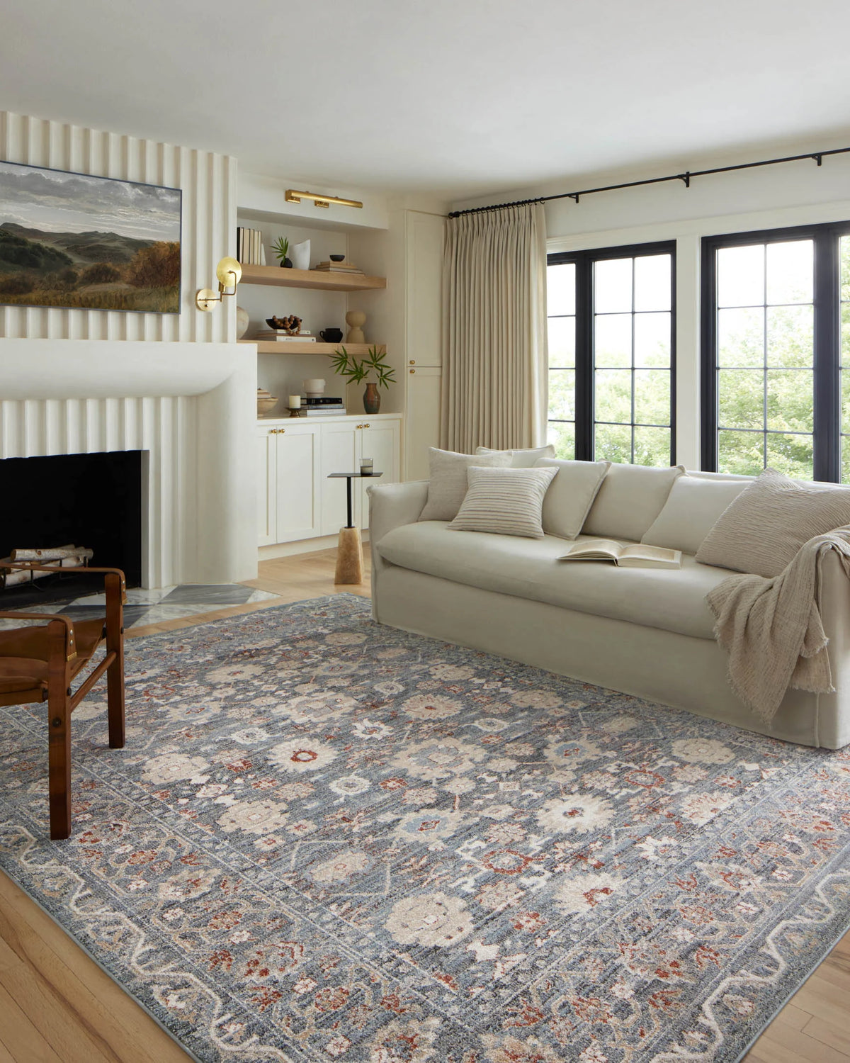 Traditional light blue area rug with ornate distressed motifs and rust highlights, rectangular