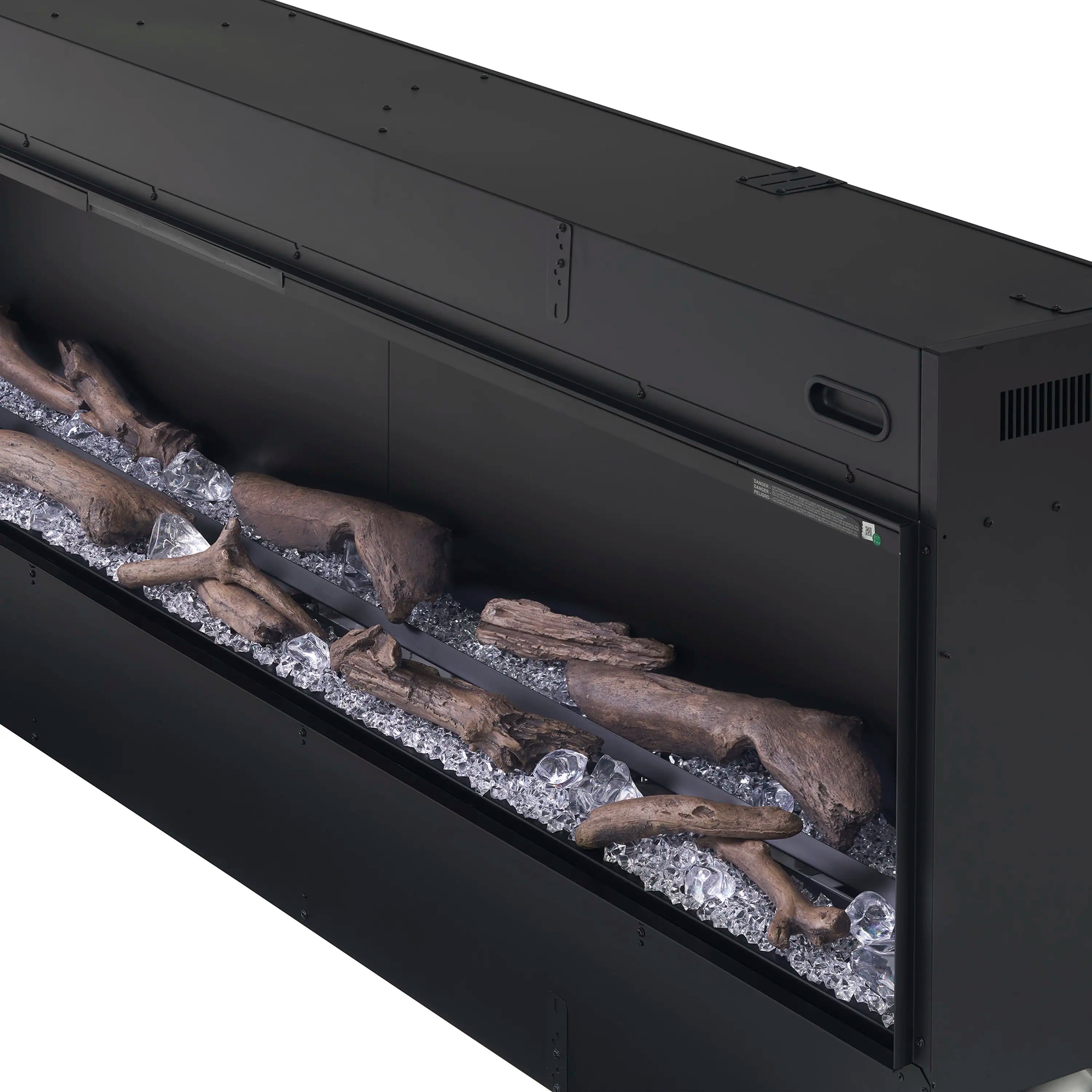 Black linear fireplace interior with driftwood logs over acrylic ice crystals