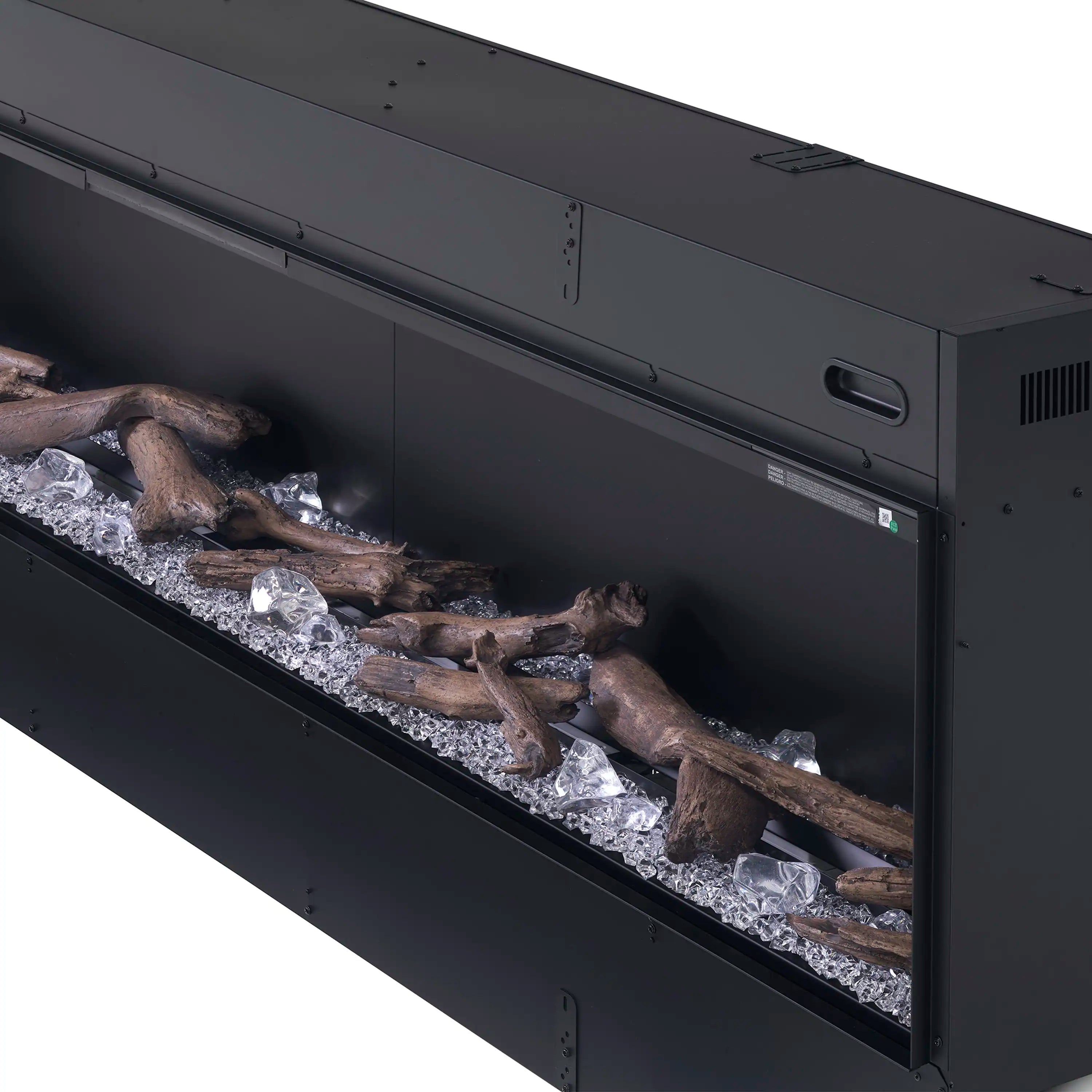 Black linear water vapor fireplace with acrylic ice and driftwood media visible