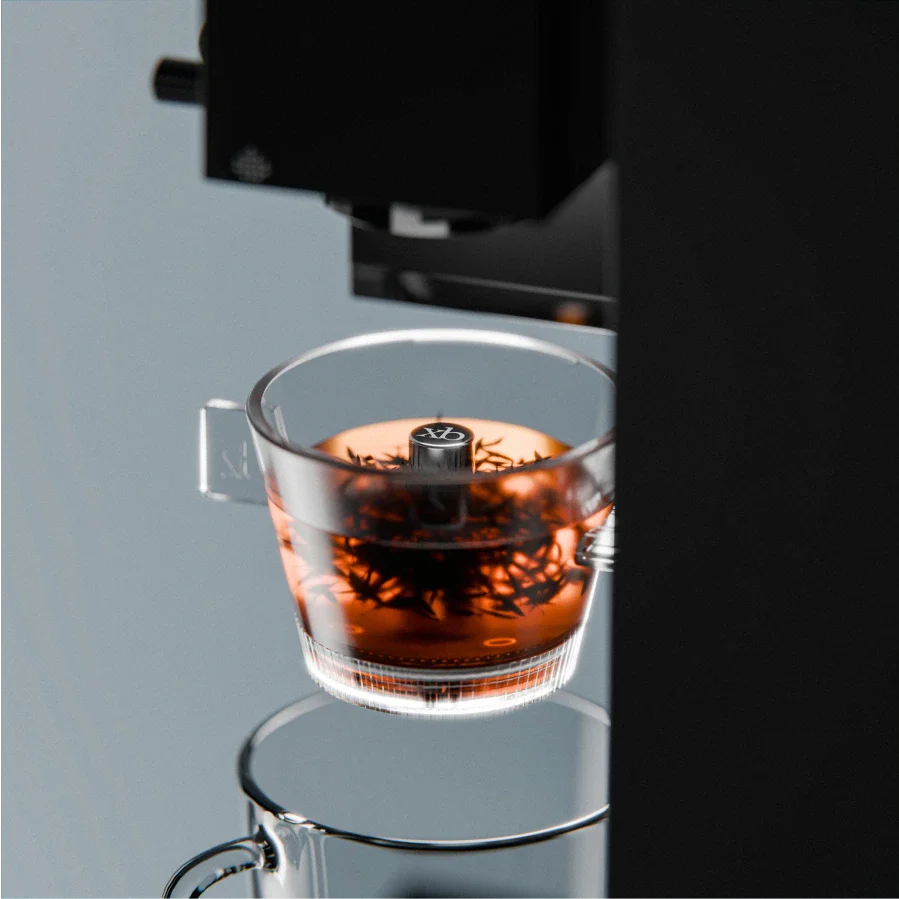Transparent tea brewer cup with amber tea and open top, angled view