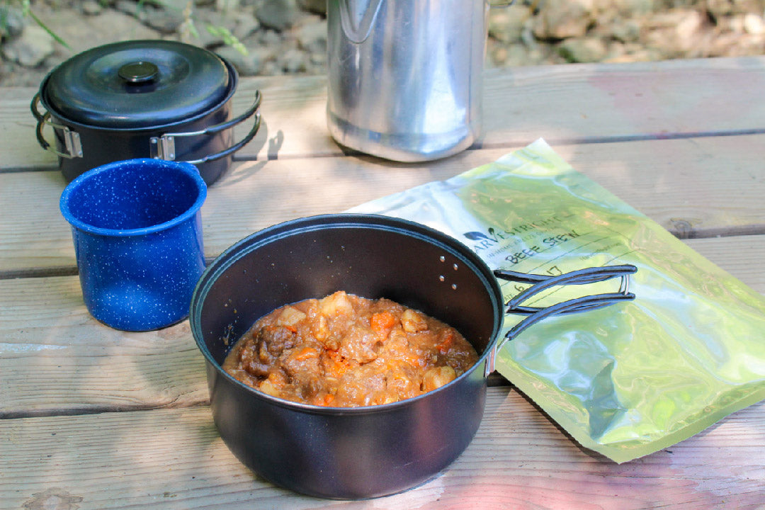 Freeze dryer food in a black pot with sealed mylar bags on a wooden table