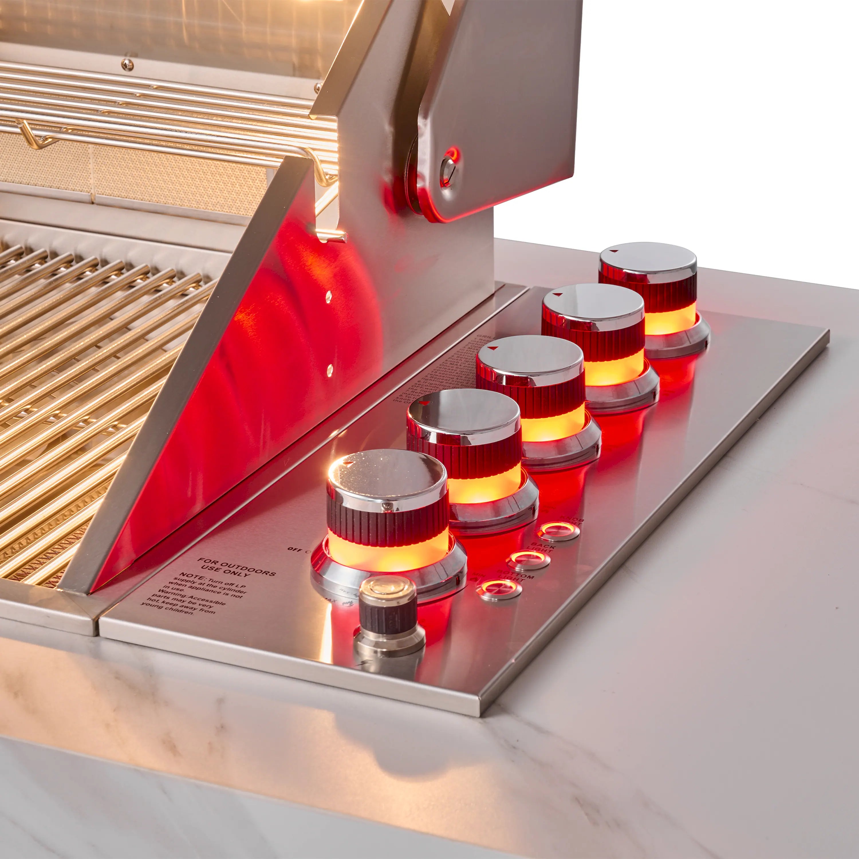 Close-up of BBQ grill control area with red-lit knobs and burner access panel