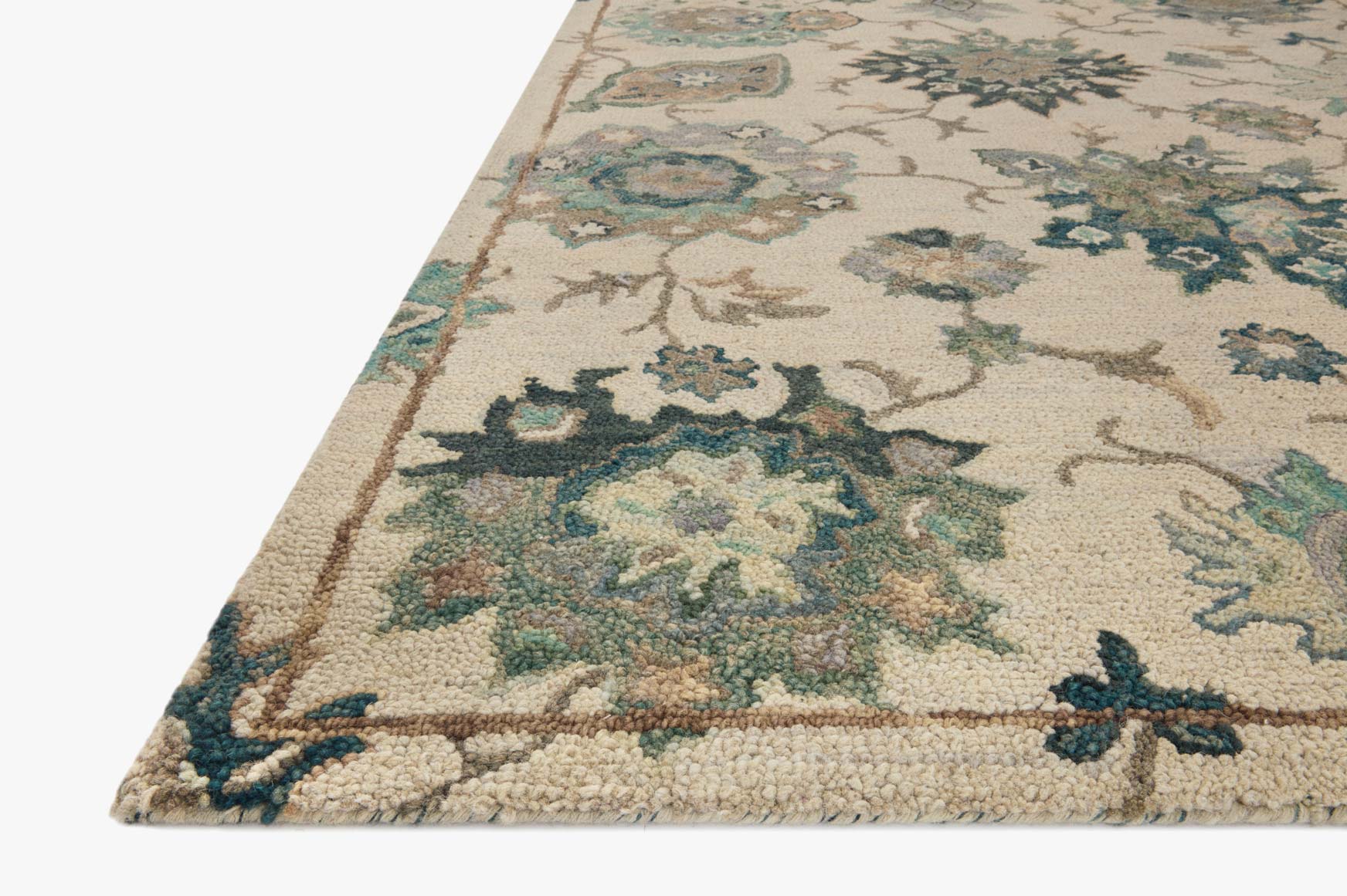Round accent rug with ivory base and blue-green floral medallion pattern, textured pile