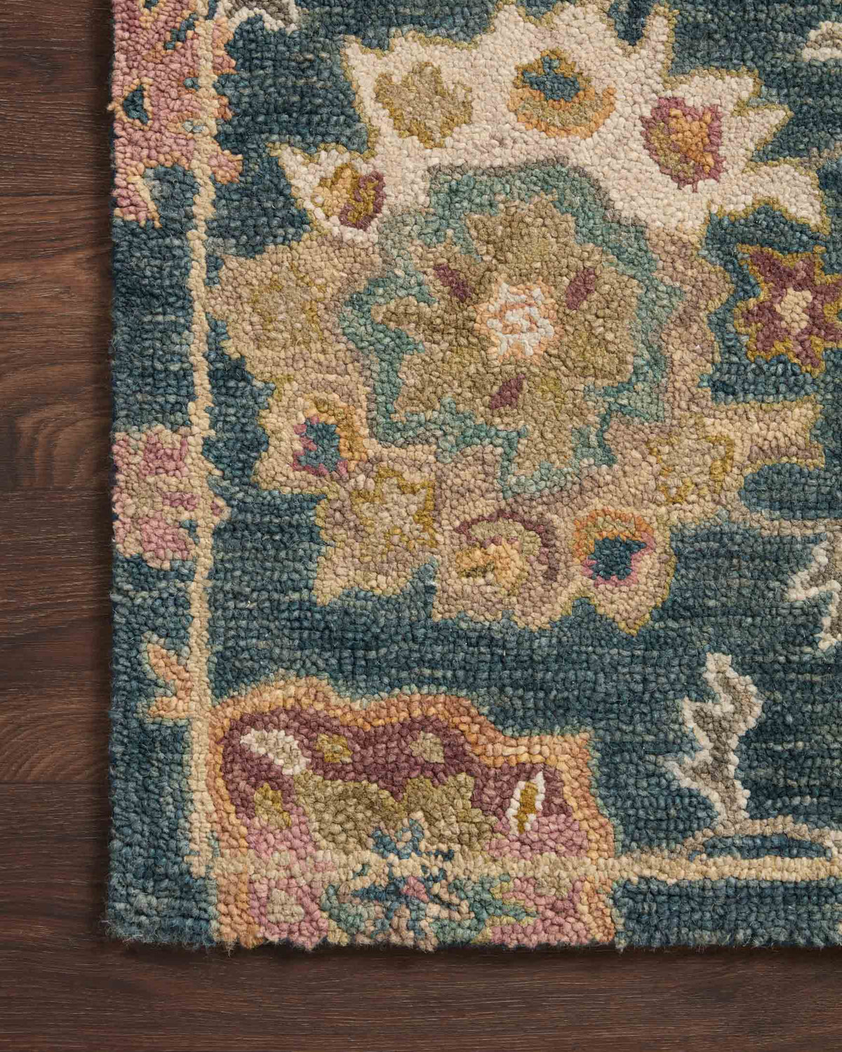 Multicolor floral medallion pattern on navy runner rug edge with dense pile texture