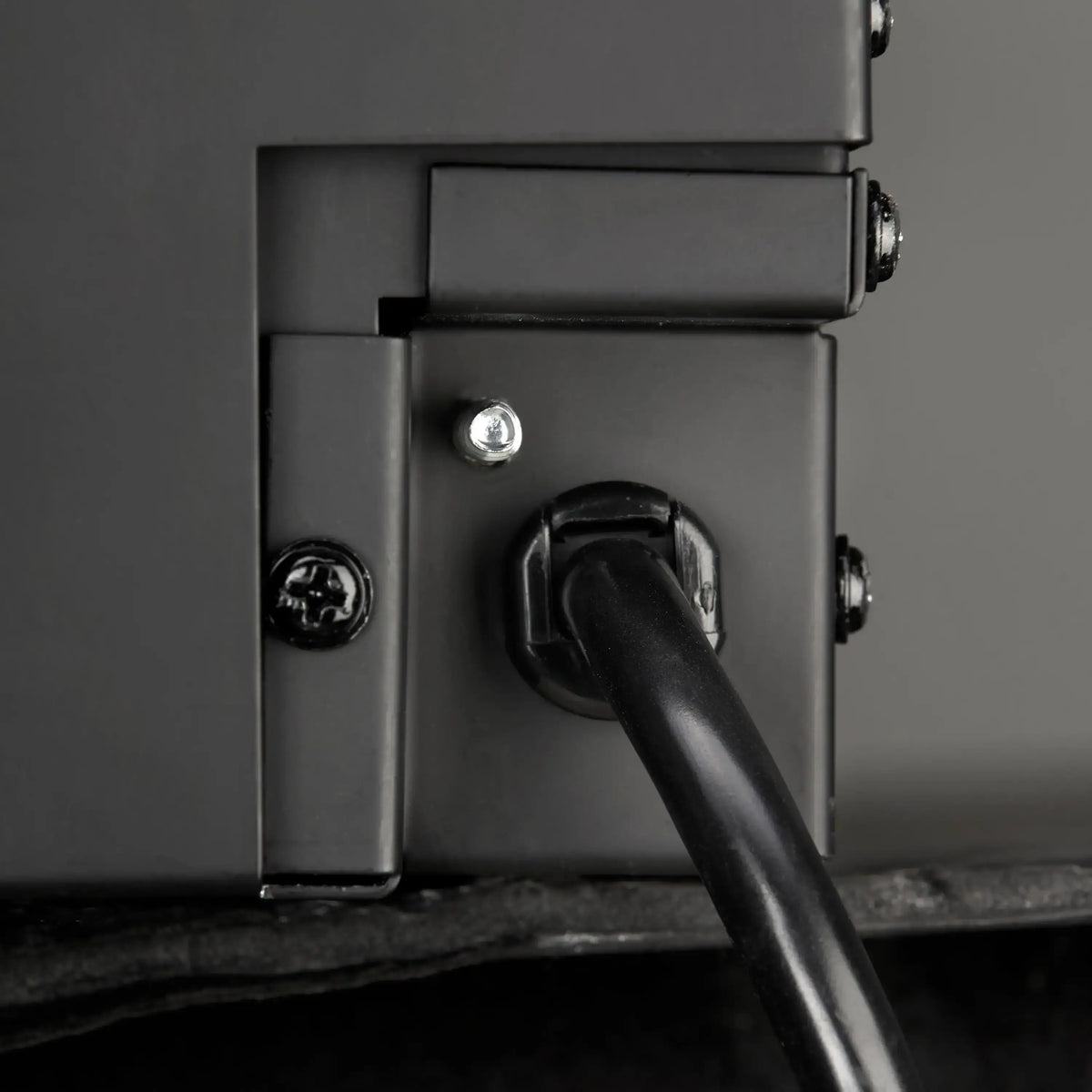 Linear electric fireplace power connector and cable on dark frame