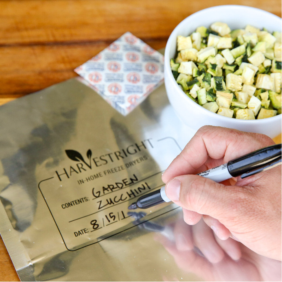 Hand writing on a sealed freeze-dried food bag with a marker