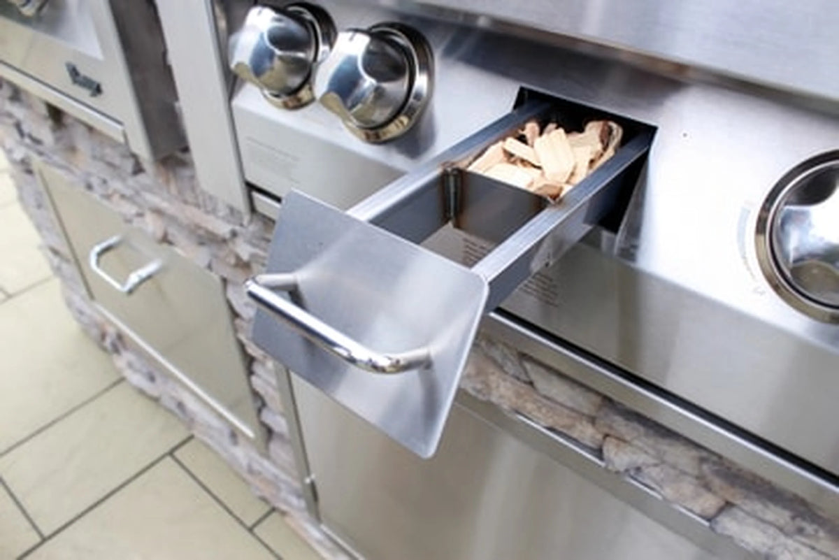 Stainless gas grill side drawer open, with interior storage and control knobs