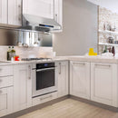 Stainless steel under-cabinet range hood with vent grille and control panel in a kitchen