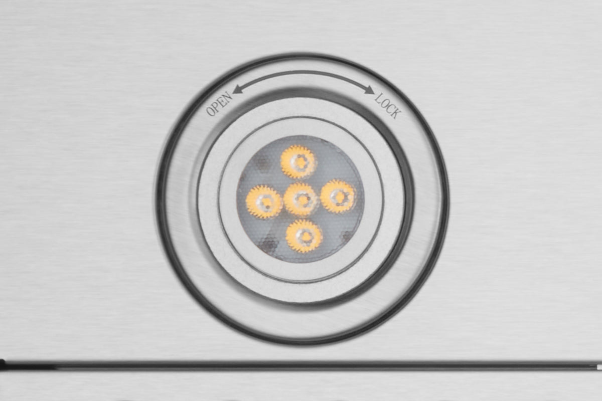 Range hood LED light lens showing four lit diodes under lock ring