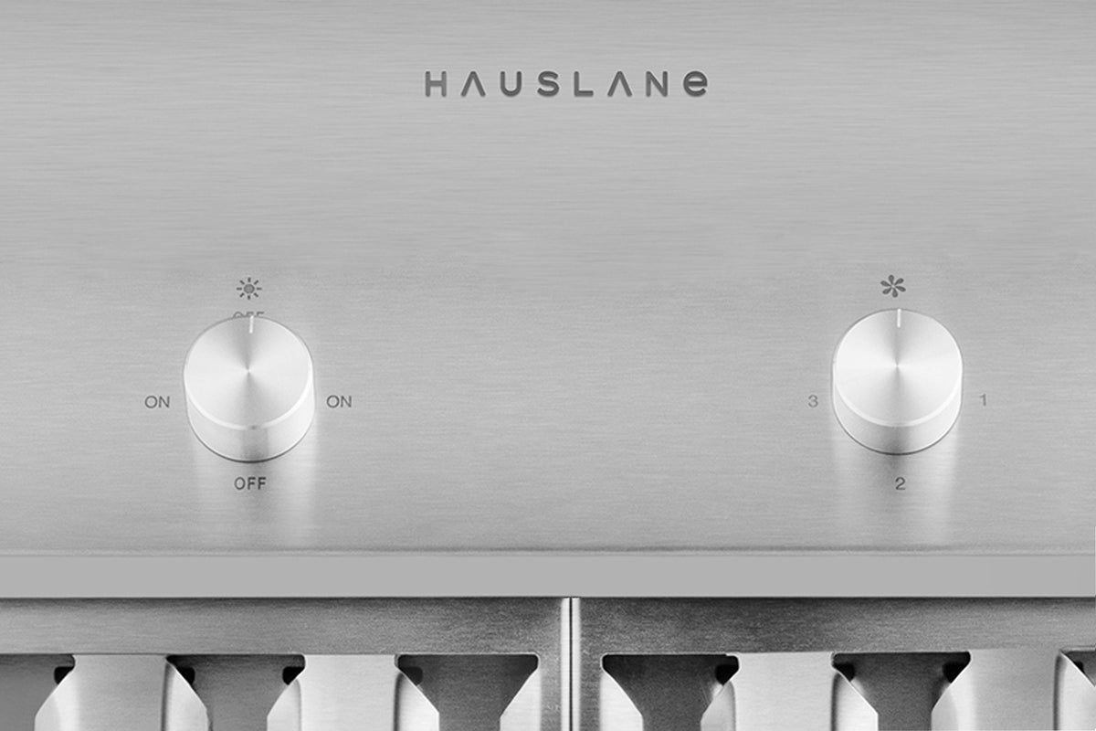 Stainless steel hood control panel with HAUSLANE logo and two round speed knobs.