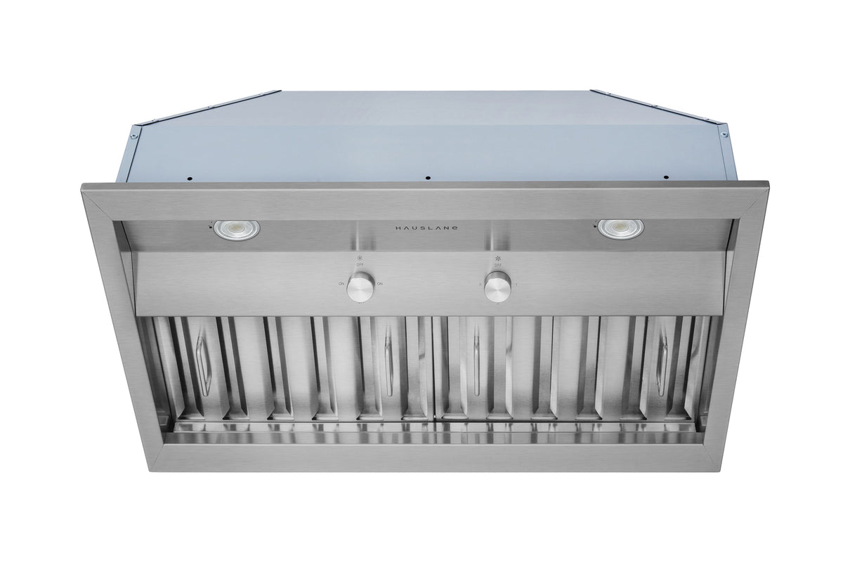 Stainless steel range hood insert with front vent louvers, centered control area, and lights.
