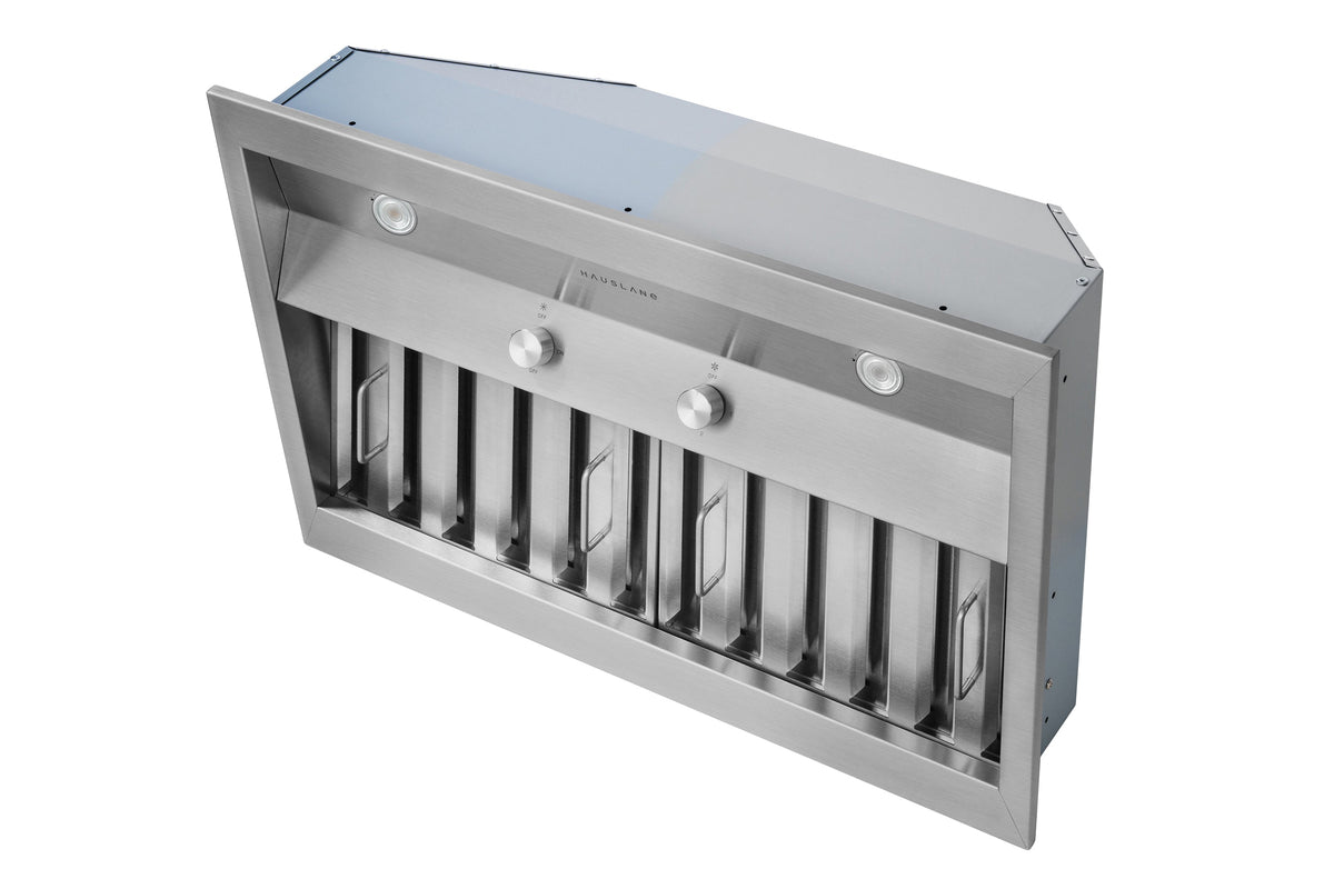 Stainless steel range hood insert from the side, showing vent louvers and control buttons.