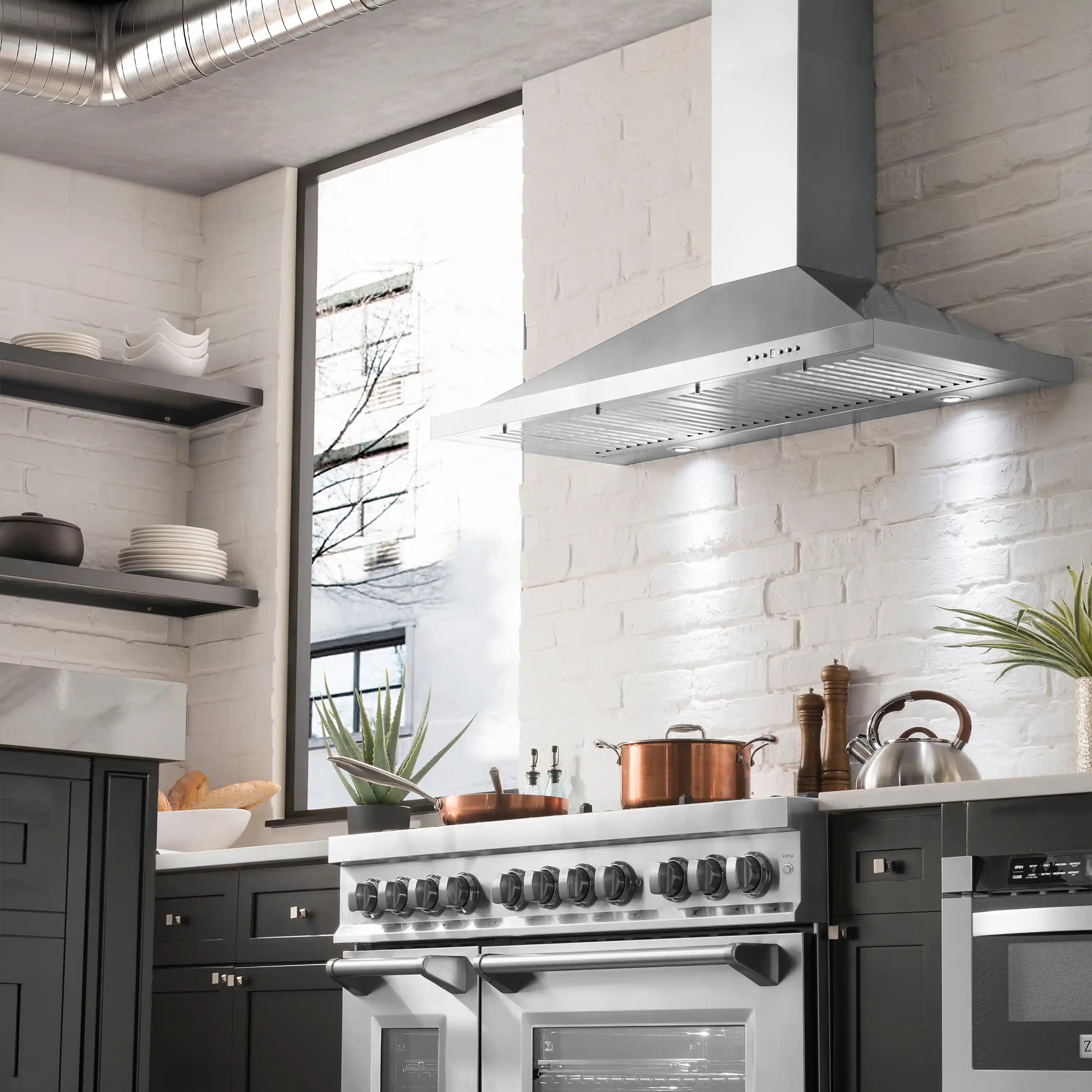 Stainless steel convertible range hood with chimney above a dual fuel range