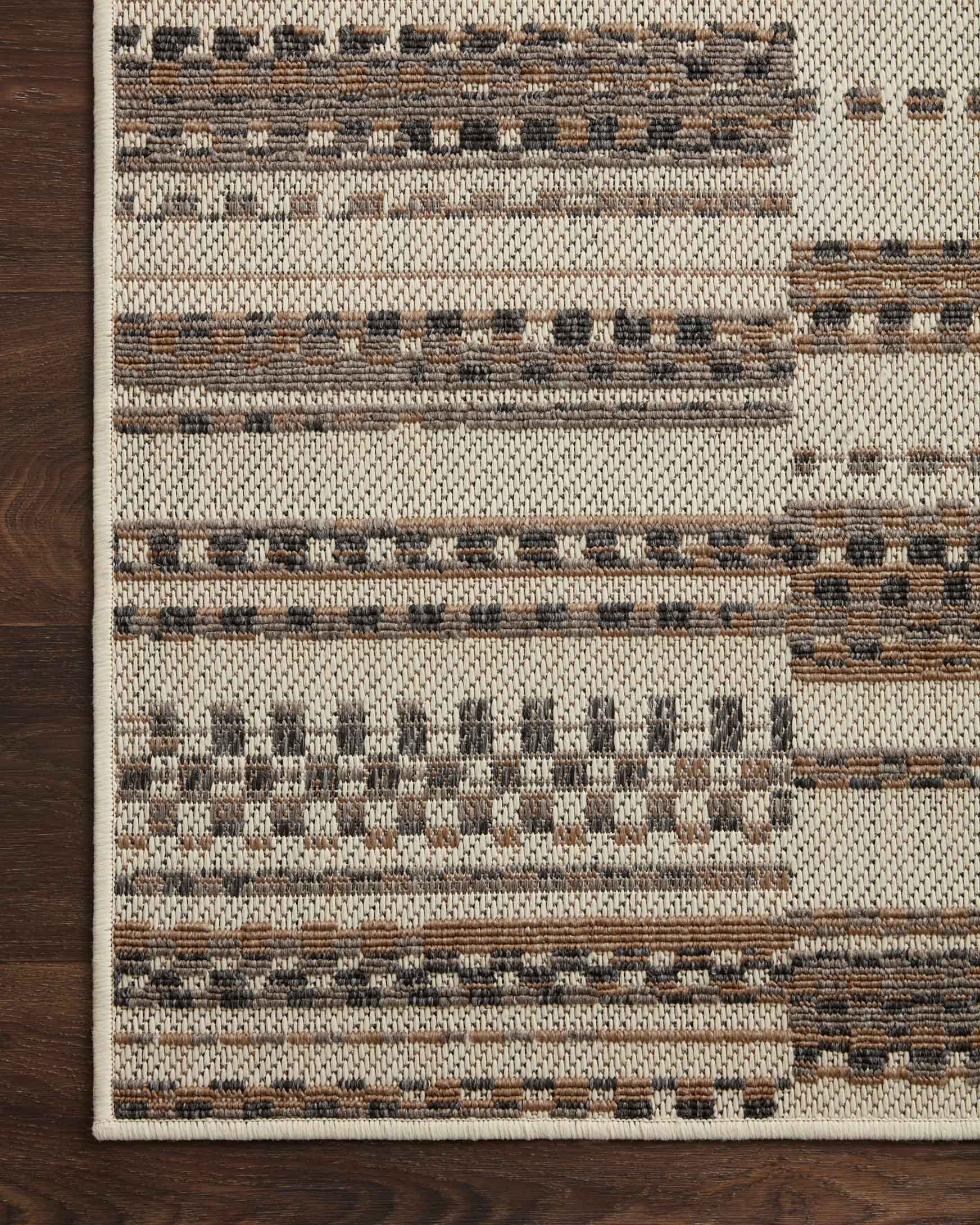 Ivory and taupe indoor/outdoor rug close-up with horizontal striped woven pattern