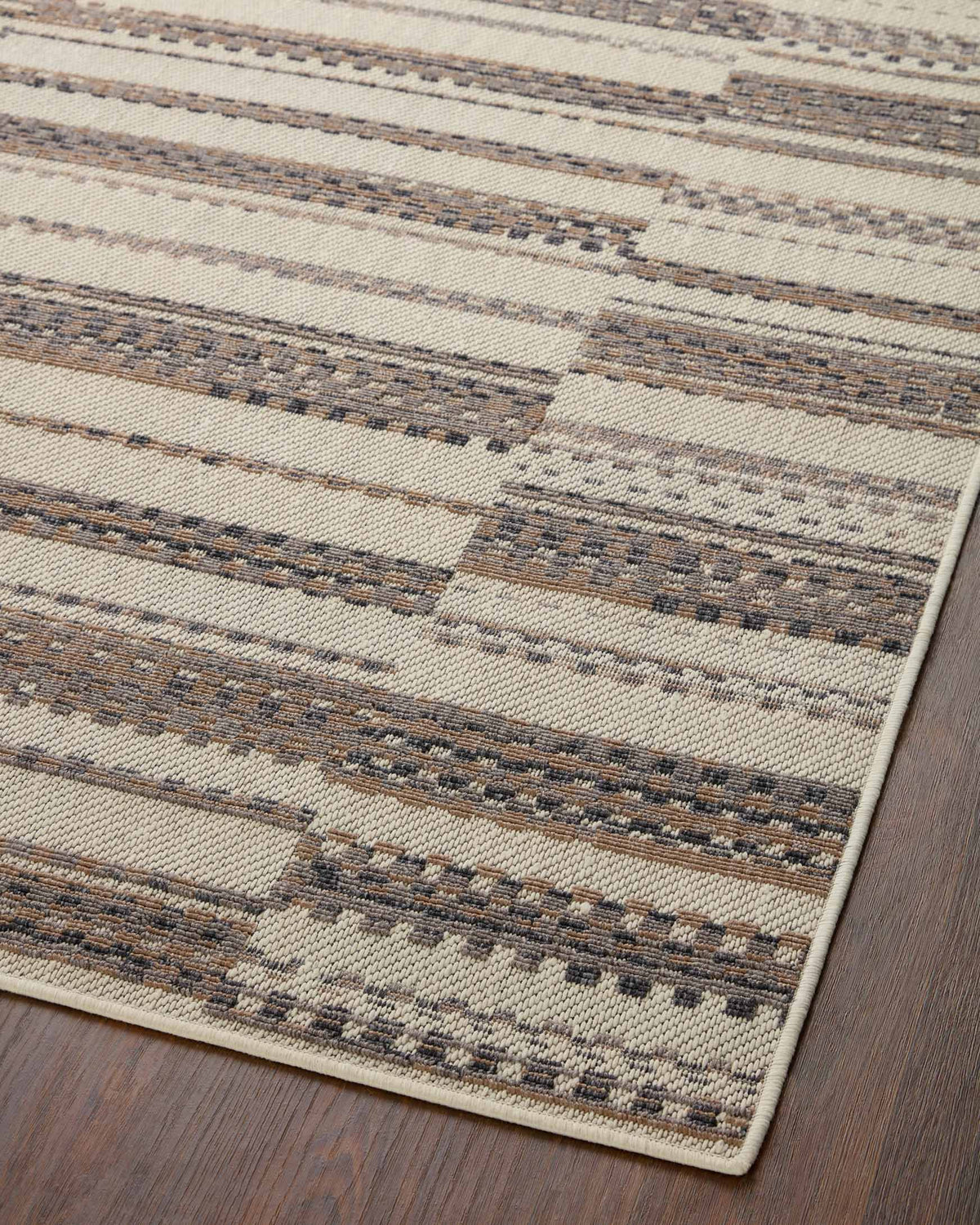 Ivory and taupe striped area rug with repeating horizontal stitched pattern lines