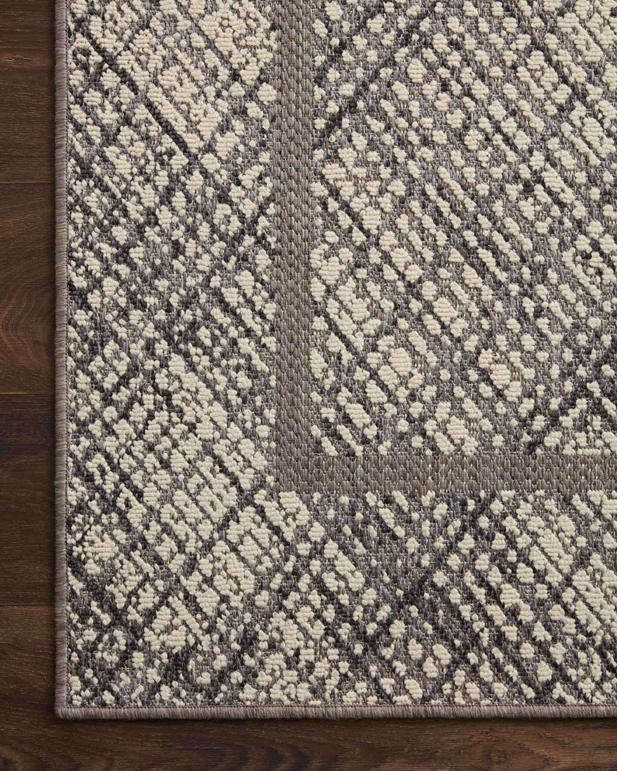 Ivory and charcoal geometric indoor/outdoor rug with diamond motifs and framed border