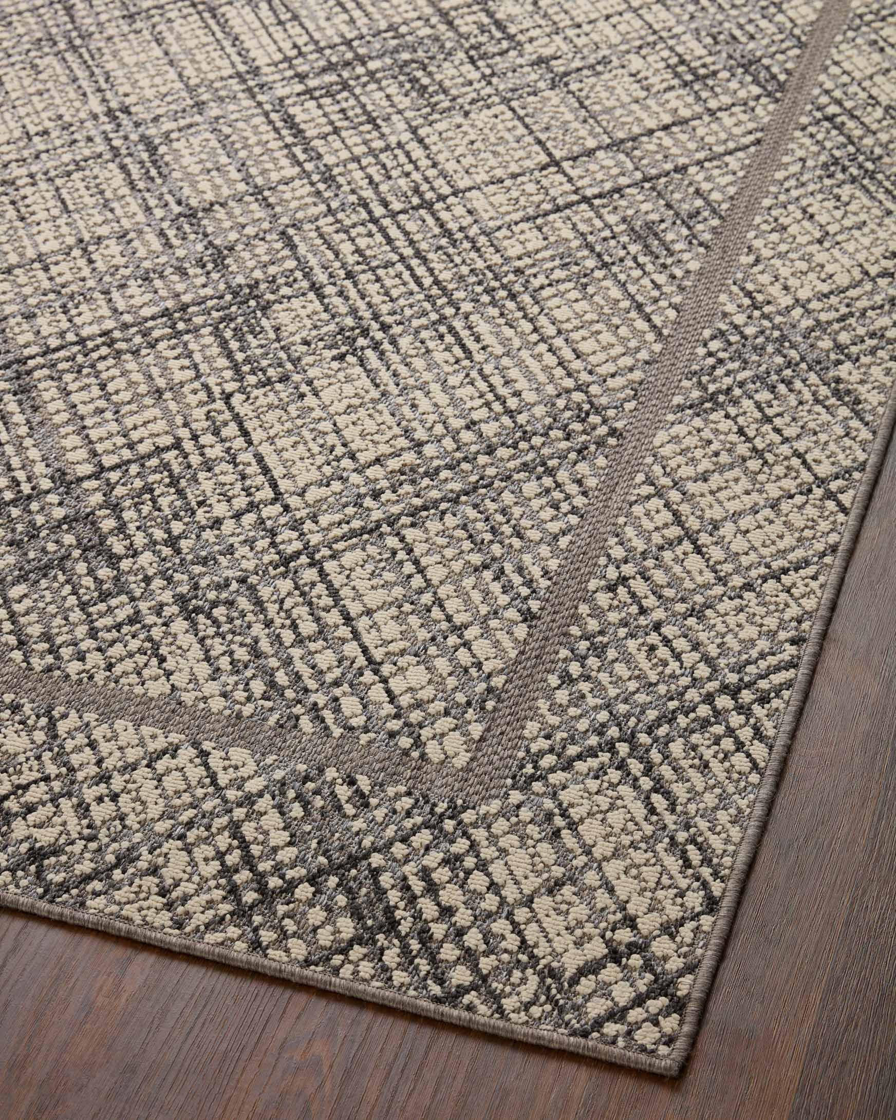 Geometric ivory-and-charcoal area rug with bordered medallion pattern