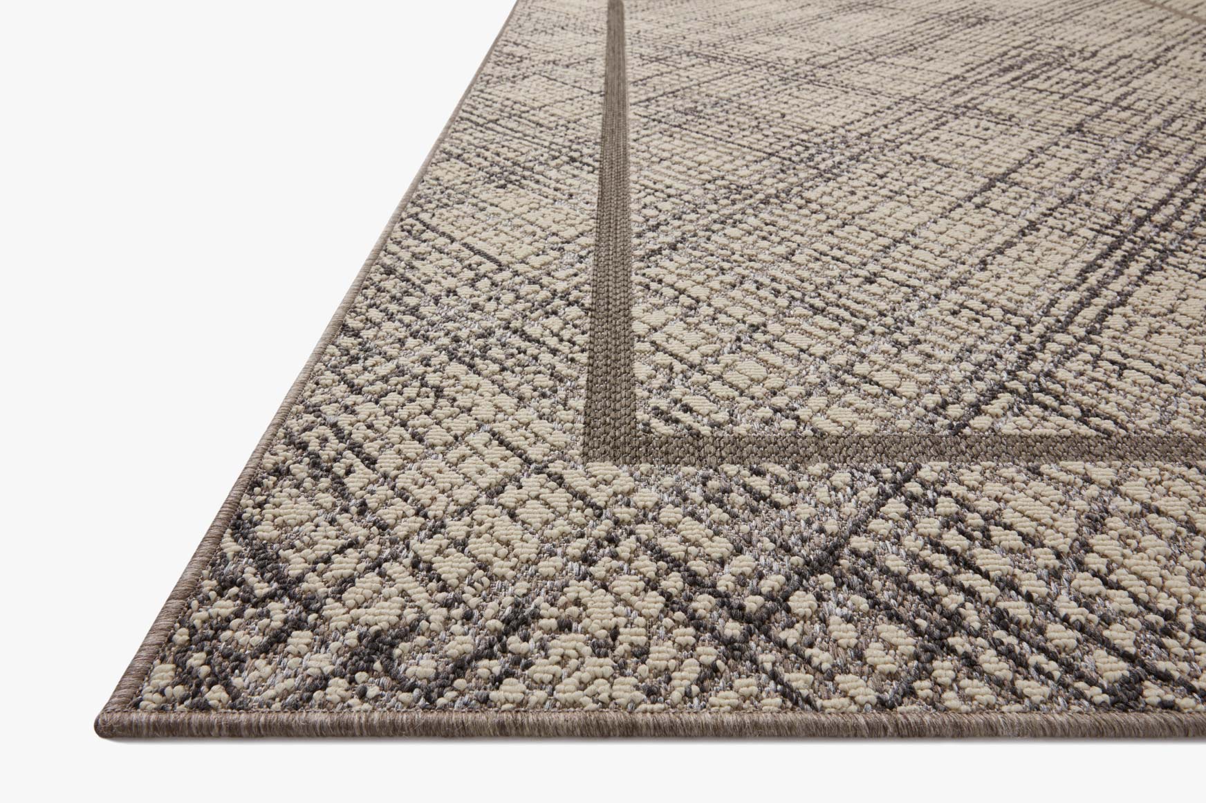 Loloi Rainier indoor/outdoor area rug in ivory and charcoal, geometric corner with border