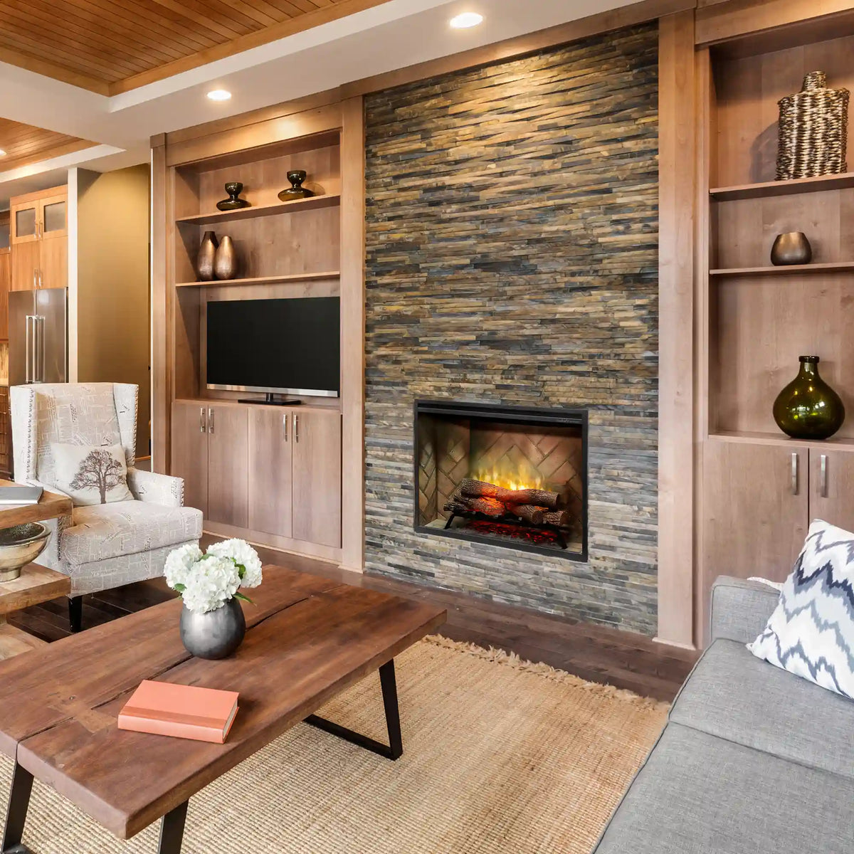 Built-in electric firebox installed in a wall with stone surround and visible flame effect
