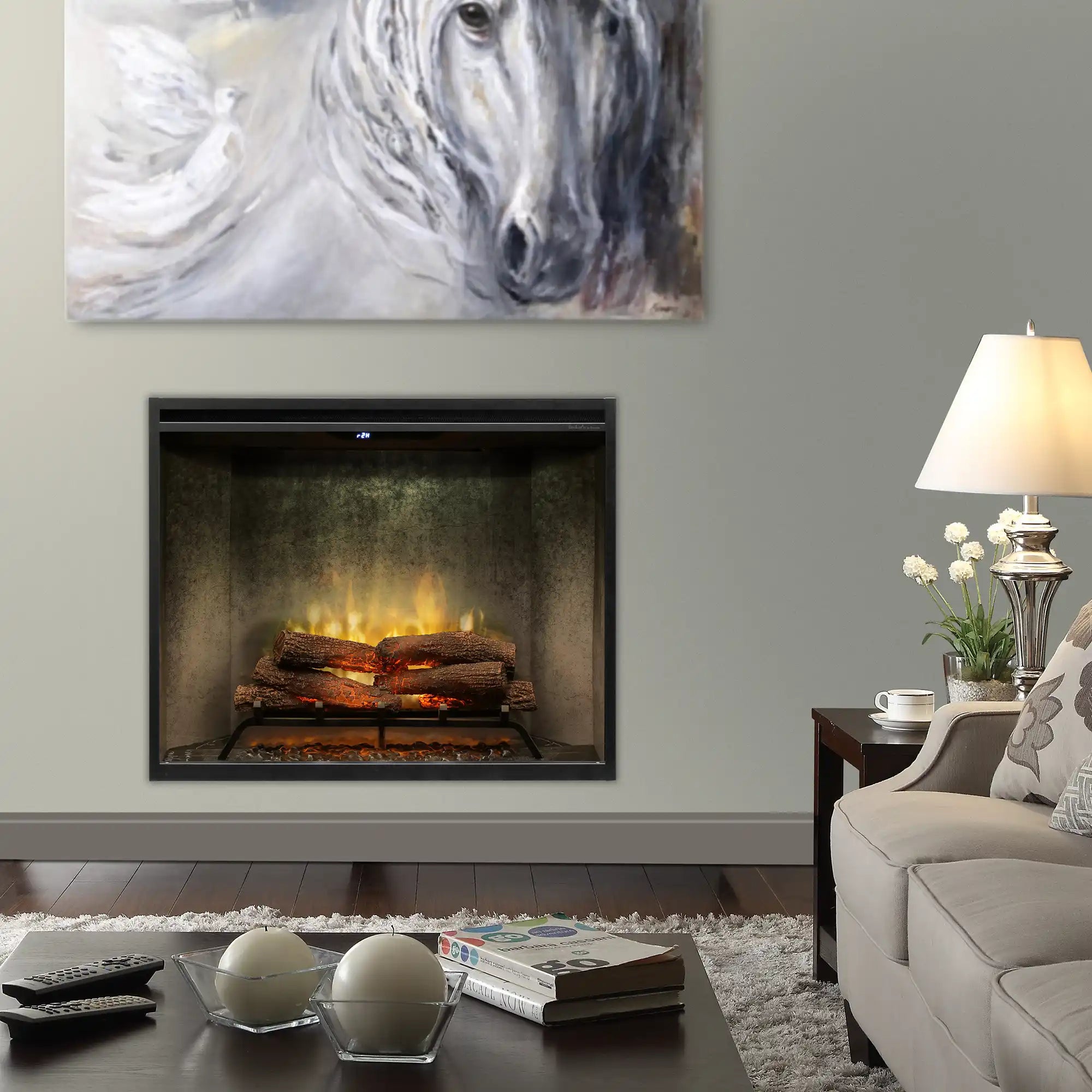 Built-in electric firebox in weathered concrete surround with flame effect and dark opening