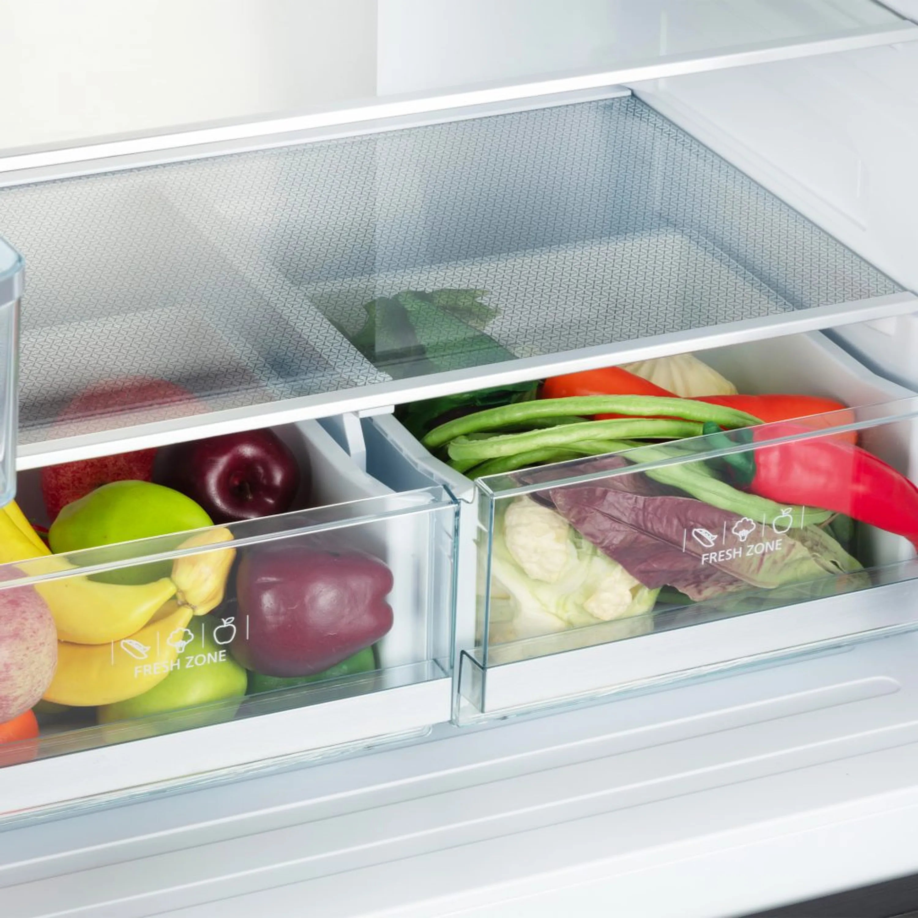 Refrigerator interior with clear drawers holding fresh produce in lower compartment