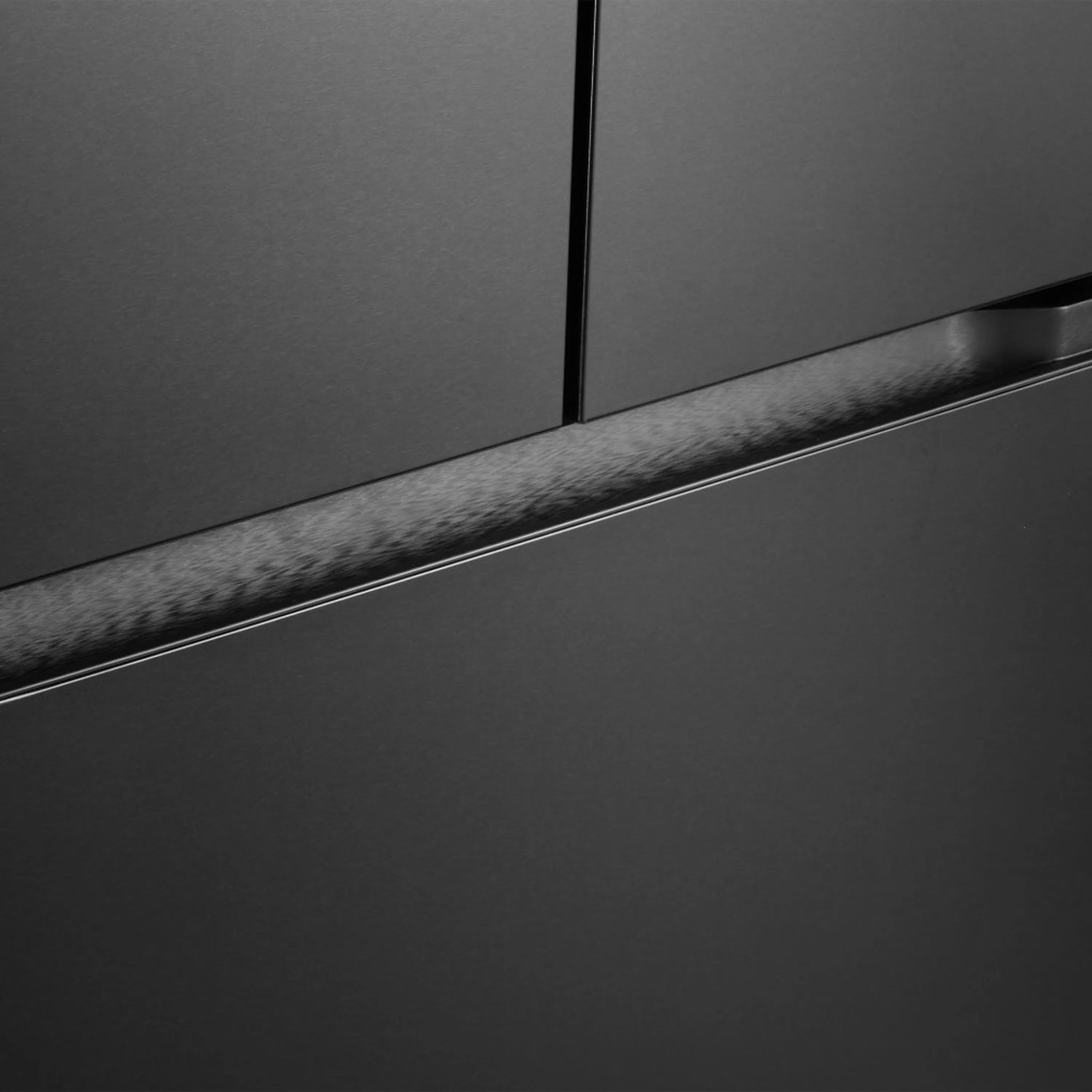 Matte black refrigerator lower door with recessed trim and bottom seam detail.