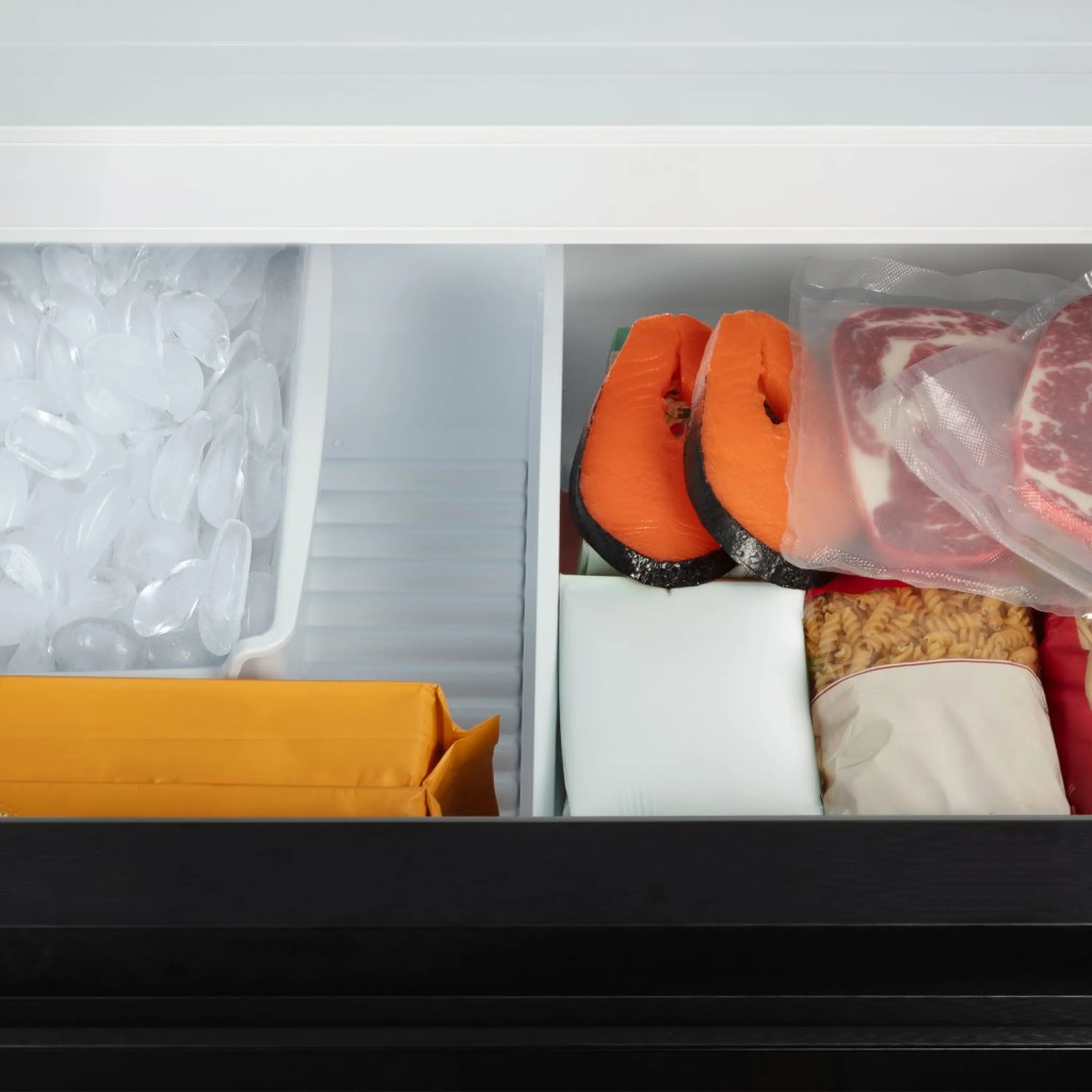 Open refrigerator interior with shelves and food items; matte black door front.