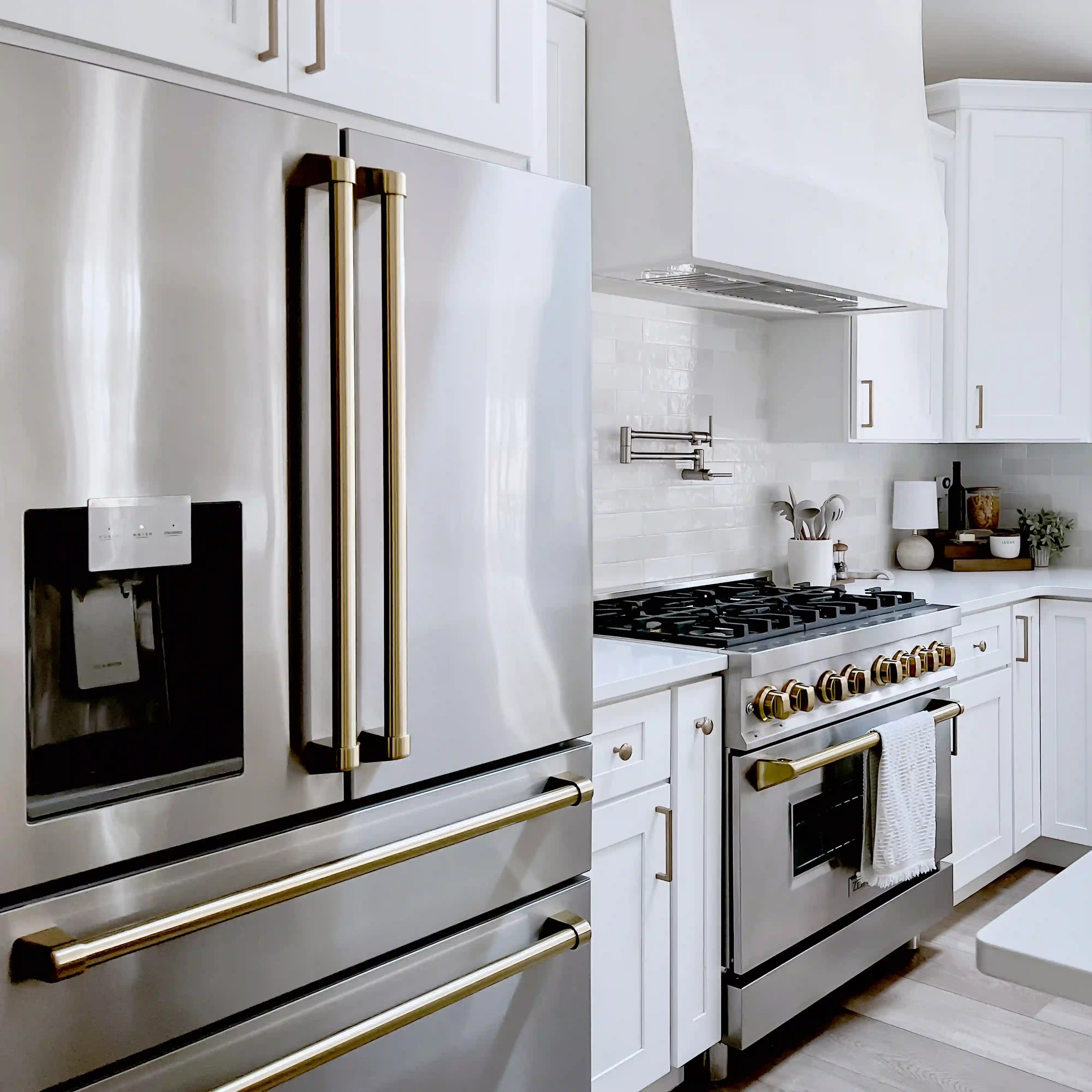 Stainless steel French door refrigerator with water/ice dispenser and champagne-bronze trim