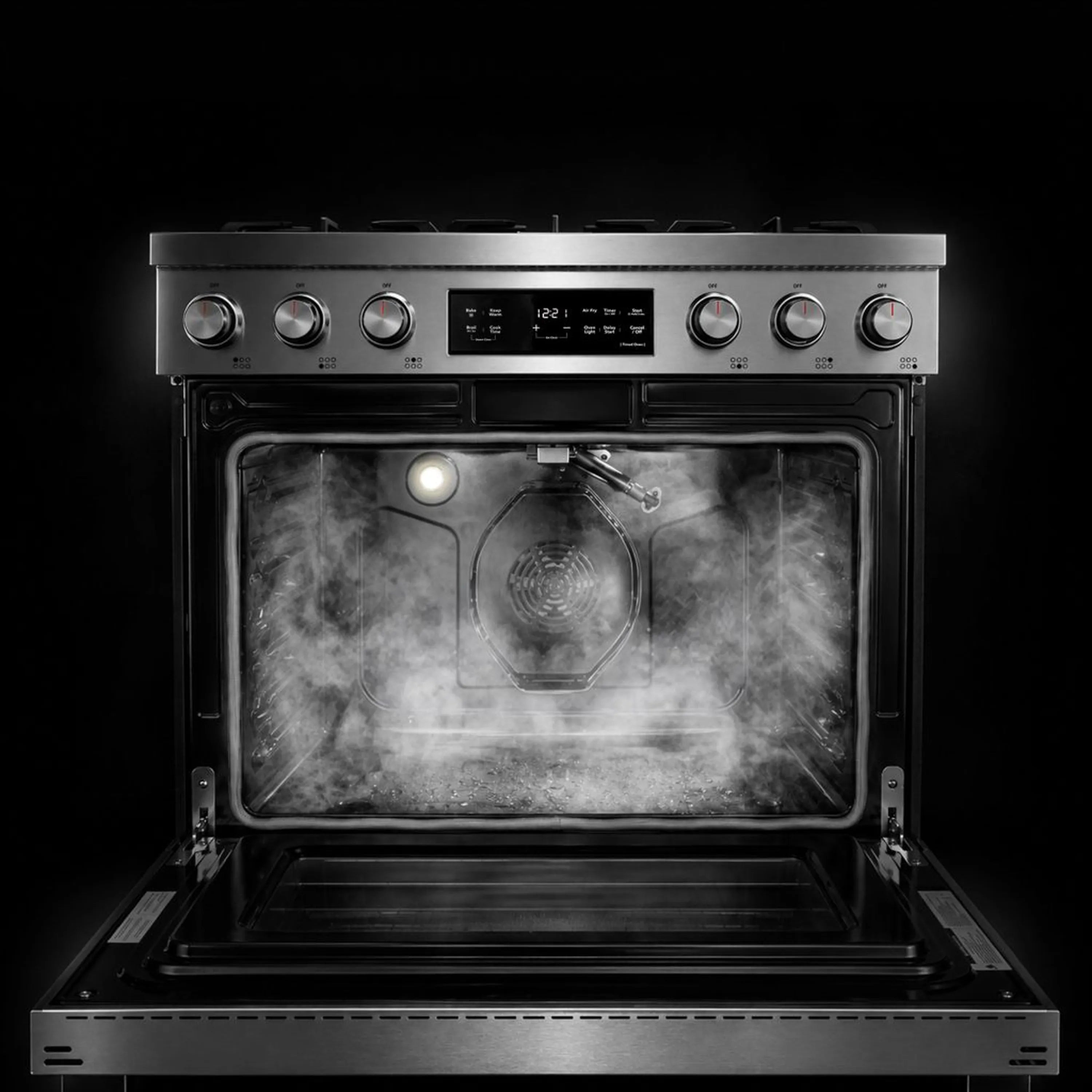 Gas oven interior with broil burner glow and racks under the cooktop