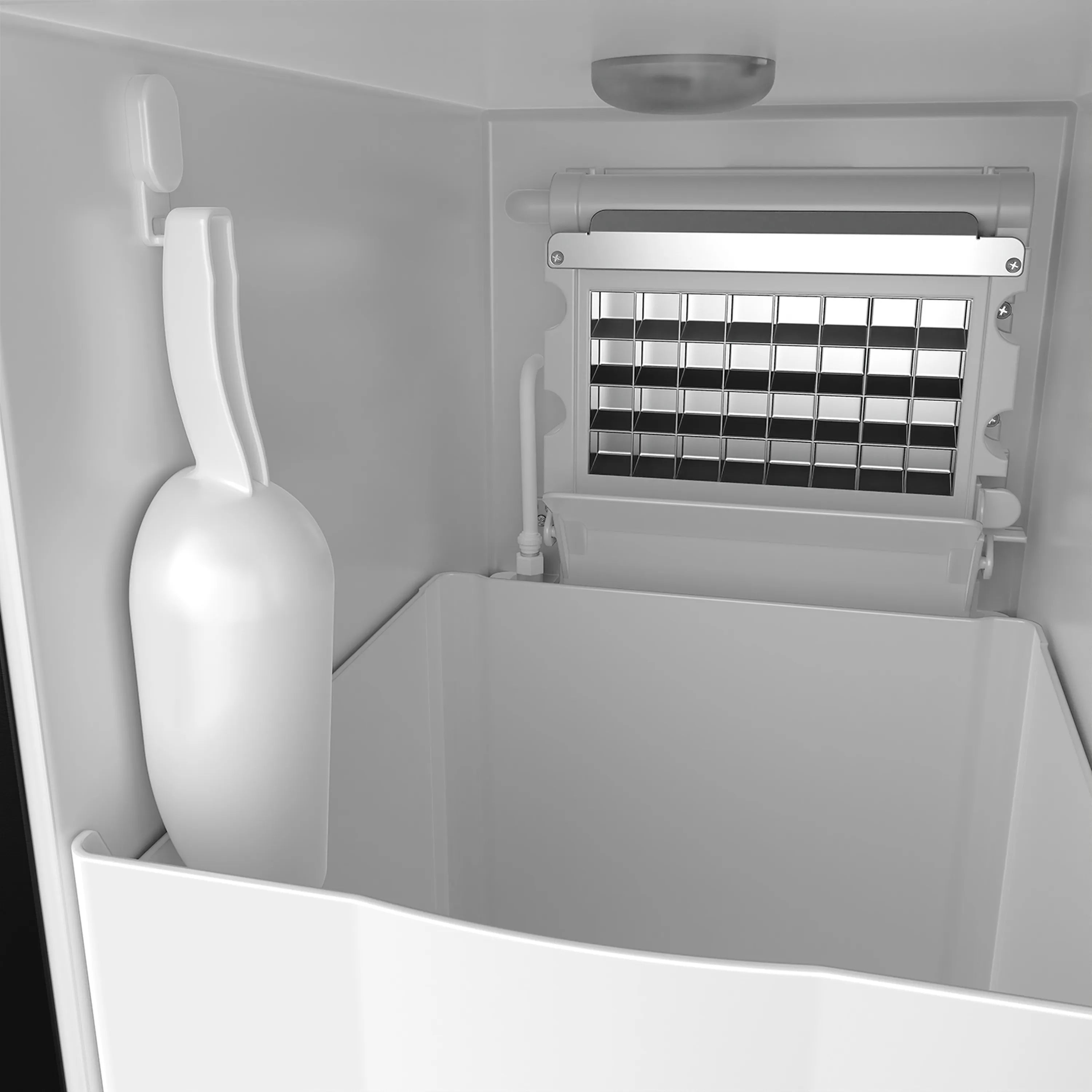 Ice maker interior with ice bin, dispensing area, and front grille