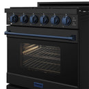 Black gas range with blue knobs, open oven showing broiler element and racks