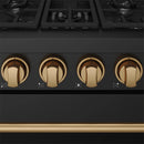 Close-up of bronze gas control knobs on black cooktop with burner markings