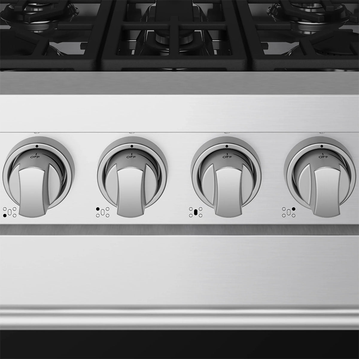 Gas range front control knobs on stainless steel panel above burner grates