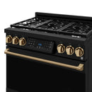 Black 36-inch gas range cooktop with bronze control screen, brass knobs, and gold handle