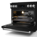 Black gas range with open self-clean oven door, oven racks, and burner igniter visible