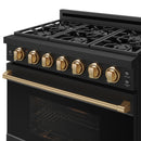 Black gas cooktop with bronze control knobs and burner grates, with front control panel.