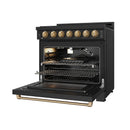 Black 36-inch gas range with bronze trim, open oven door, and visible burner area.
