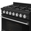 Black gas range cooktop with six stainless knobs and burner grates, side control panel close-up.