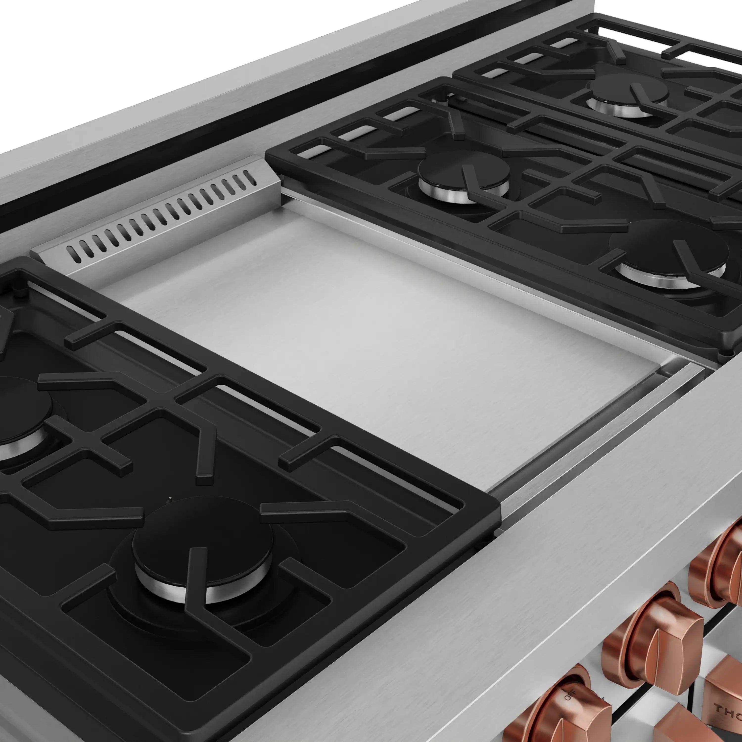 Stainless steel gas cooktop with black burner grates and rose-gold control trim