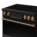 Black induction range angled view showing bronze knobs, cooktop burners, and tilt touch panel