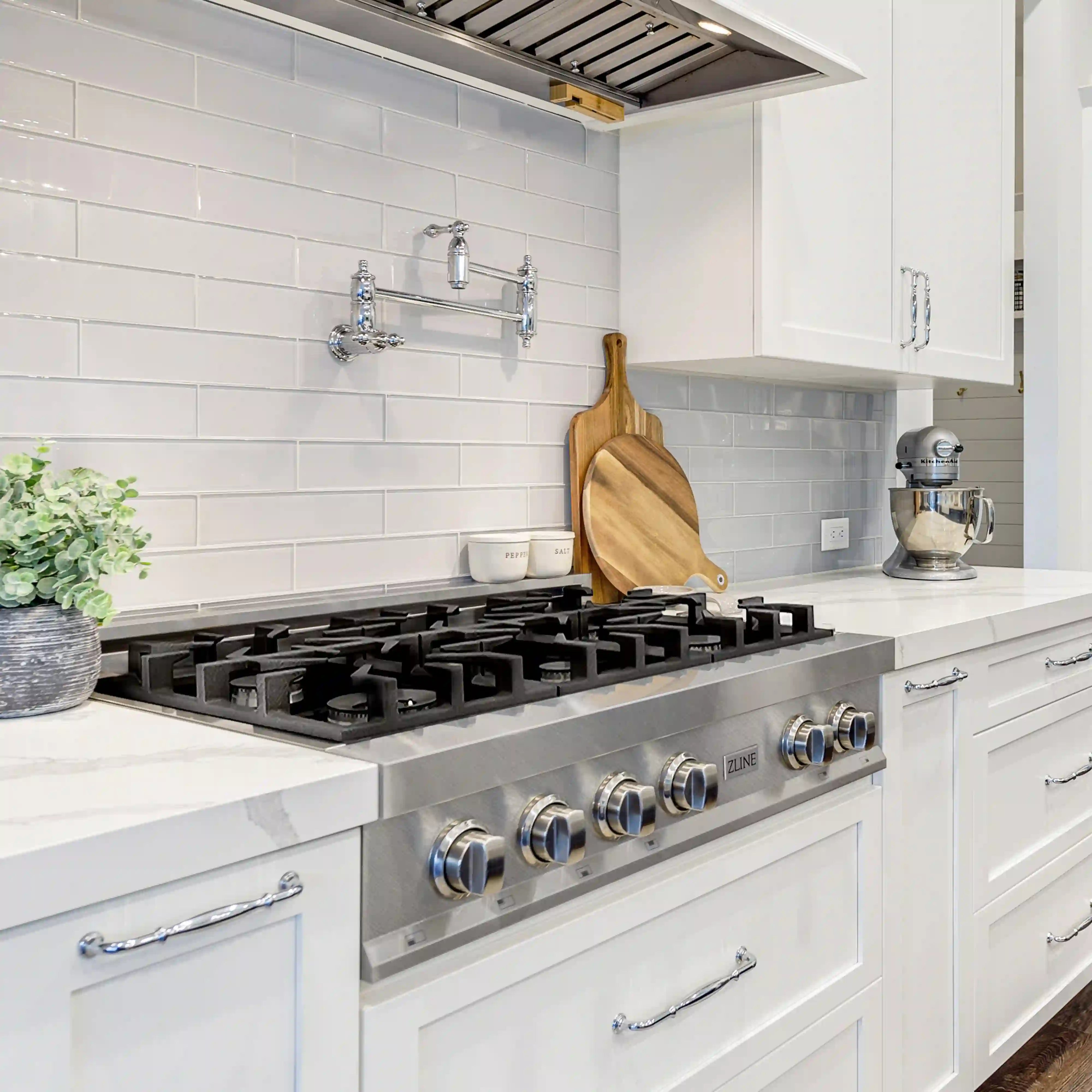 Stainless steel 36-inch gas rangetop with six black burners and metal control knobs