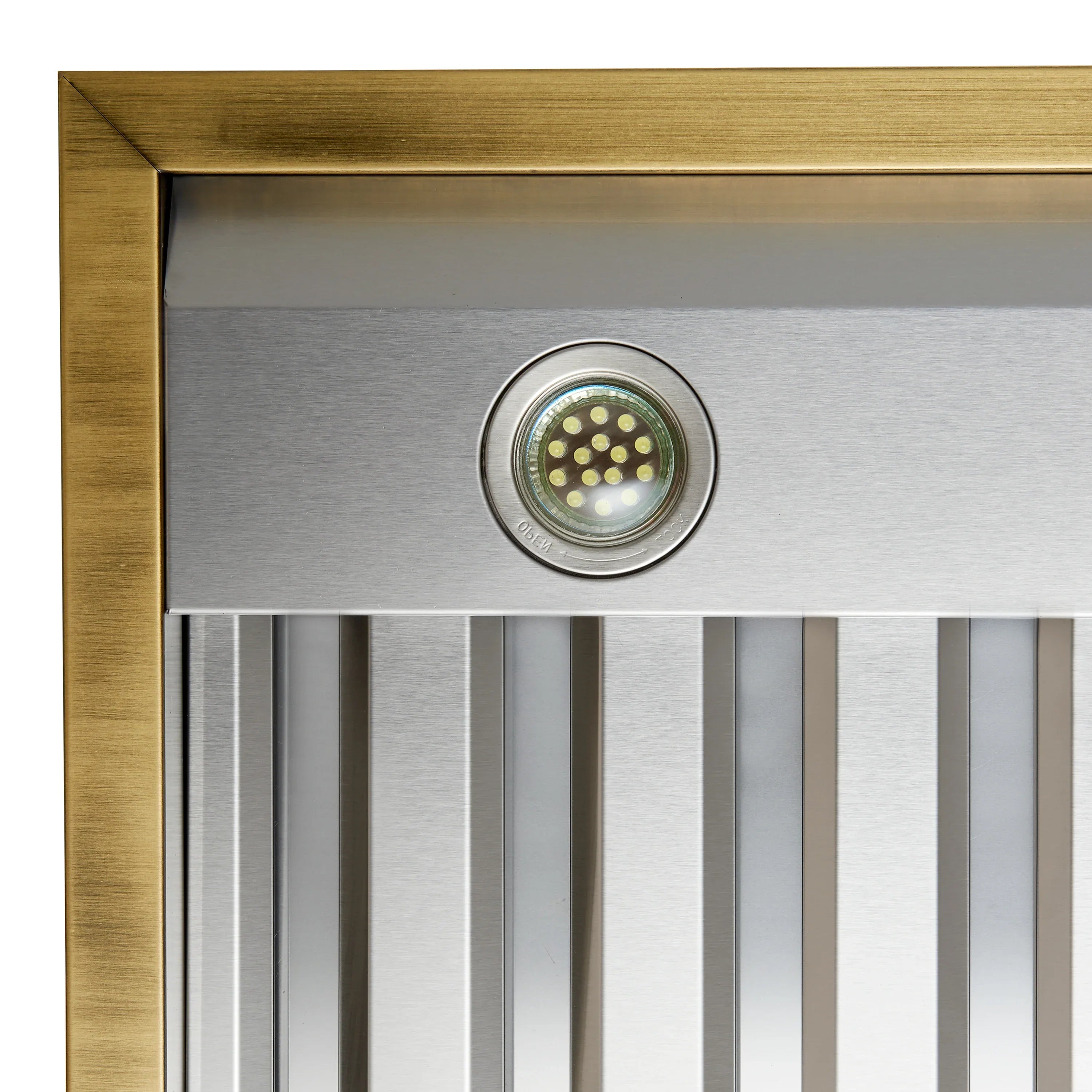 Range hood control light detail in antique brass frame with vented grille