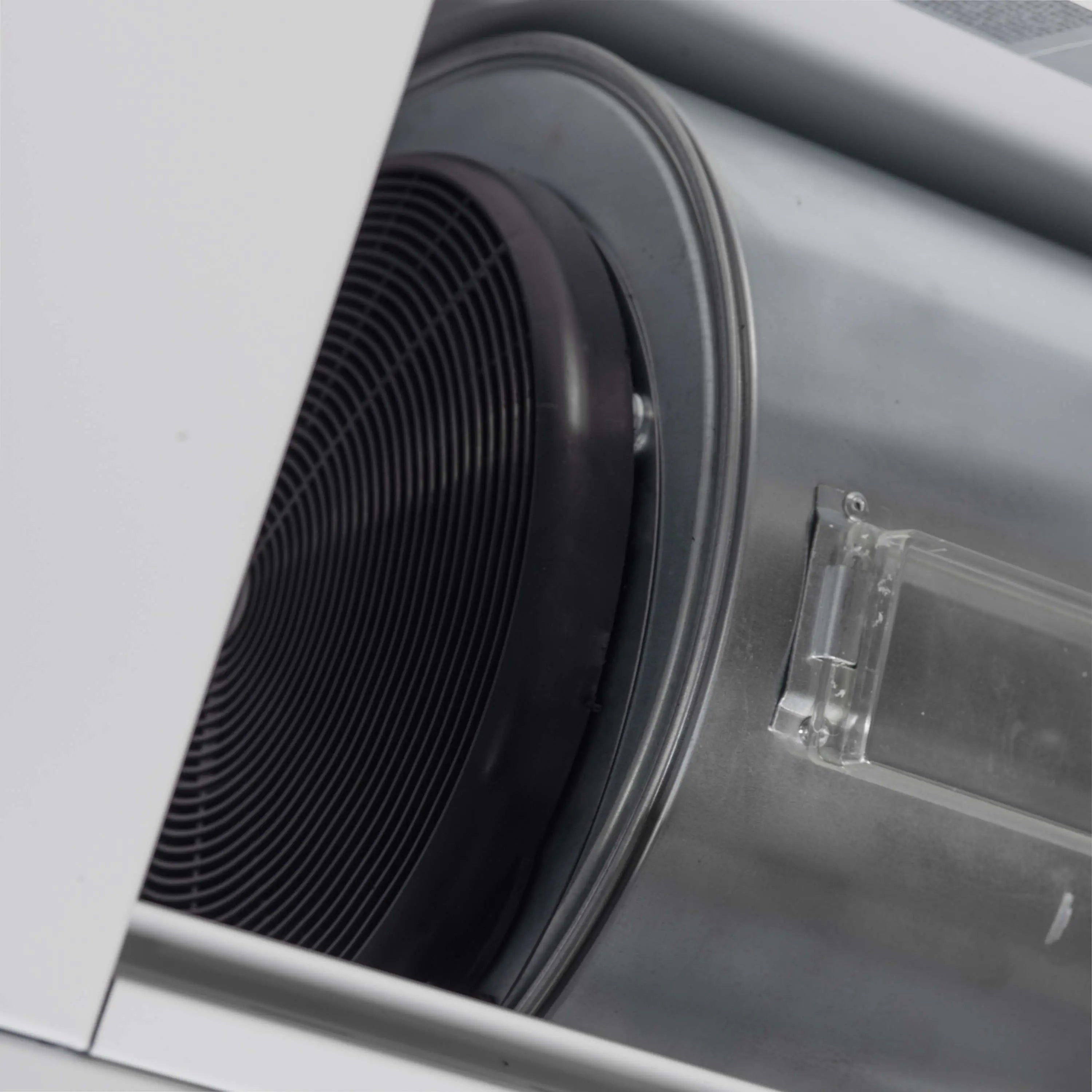 Microwave drawer ventilation fan with black ducting inside white interior