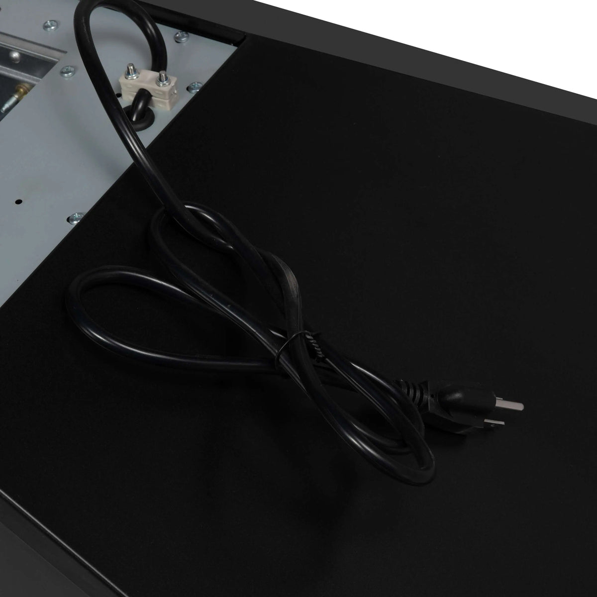 Black wall mount range hood with attached power cord and wiring