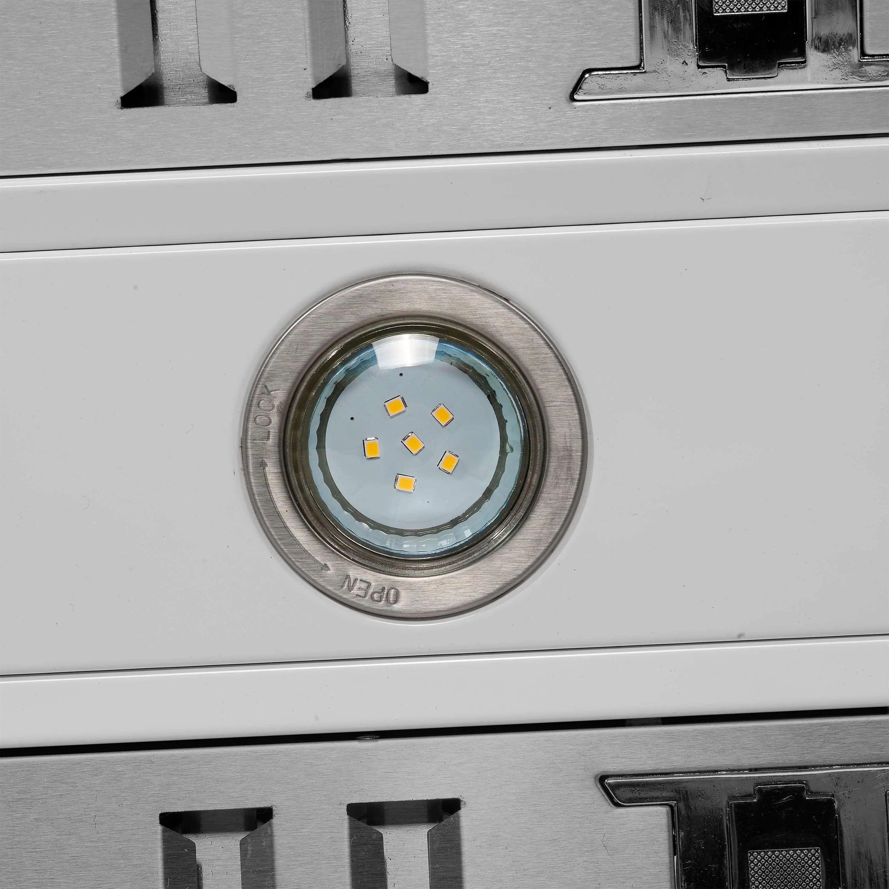 White range hood indicator area with circular LED lens and metal ring detail