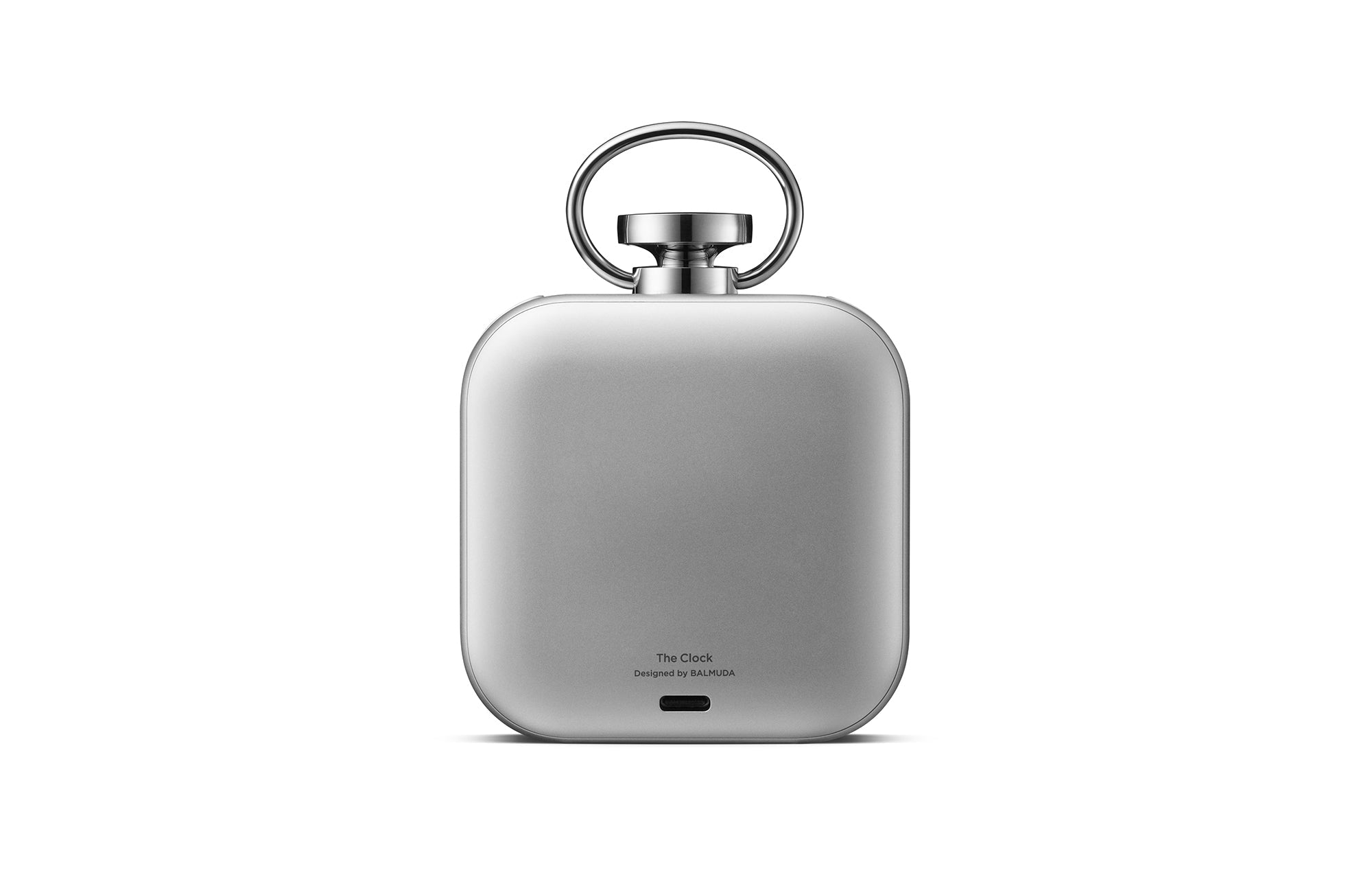 Silver desktop clock back view with top handle and bottom charging port