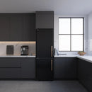 Black bottom freezer refrigerator with antique brass handle in a kitchen setting