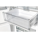Transparent glass freezer drawer with metal frame inside a white refrigerator-freezer