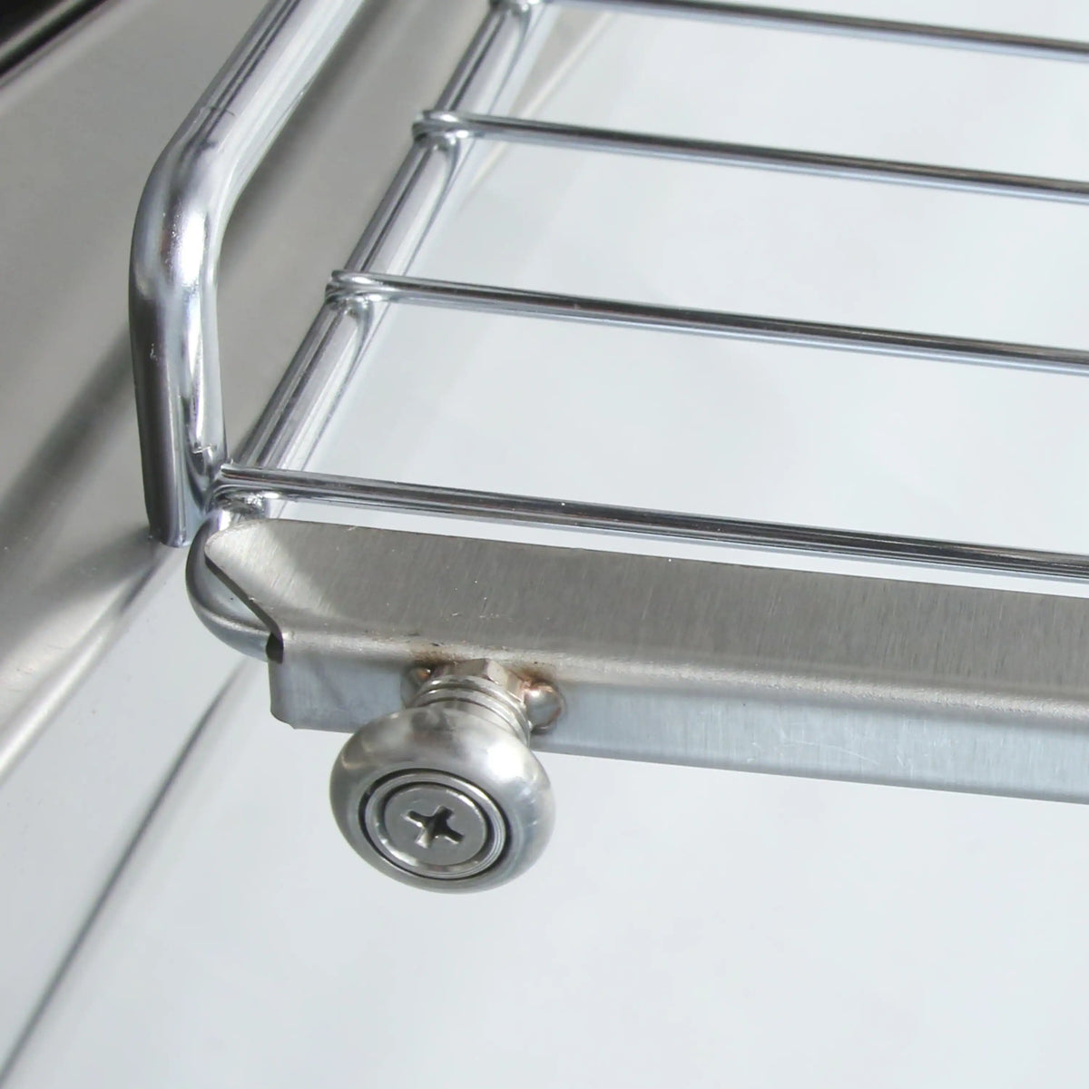 Stainless steel control area with round gas knob and metal oven handle
