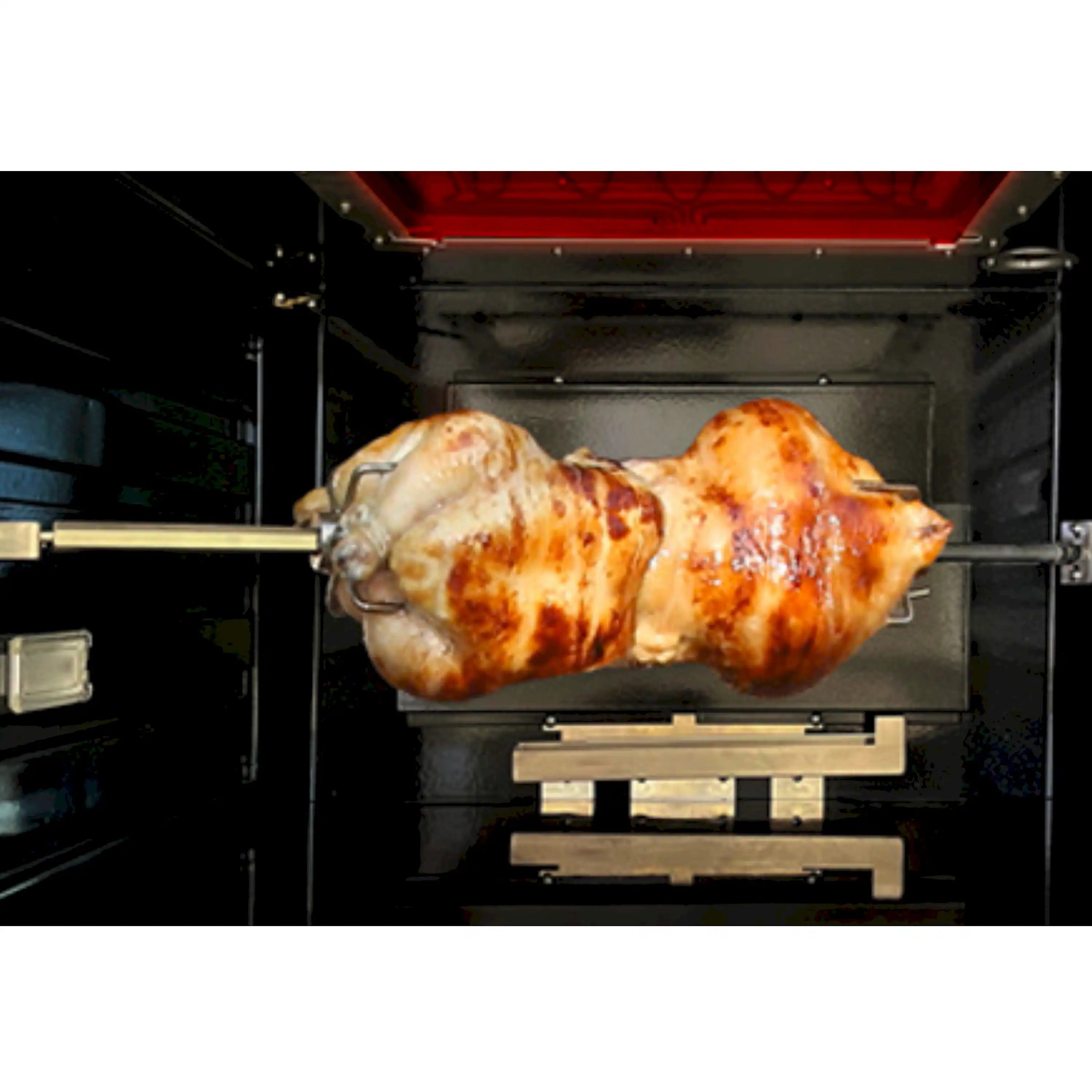 Roasting chicken on a spit inside the oven